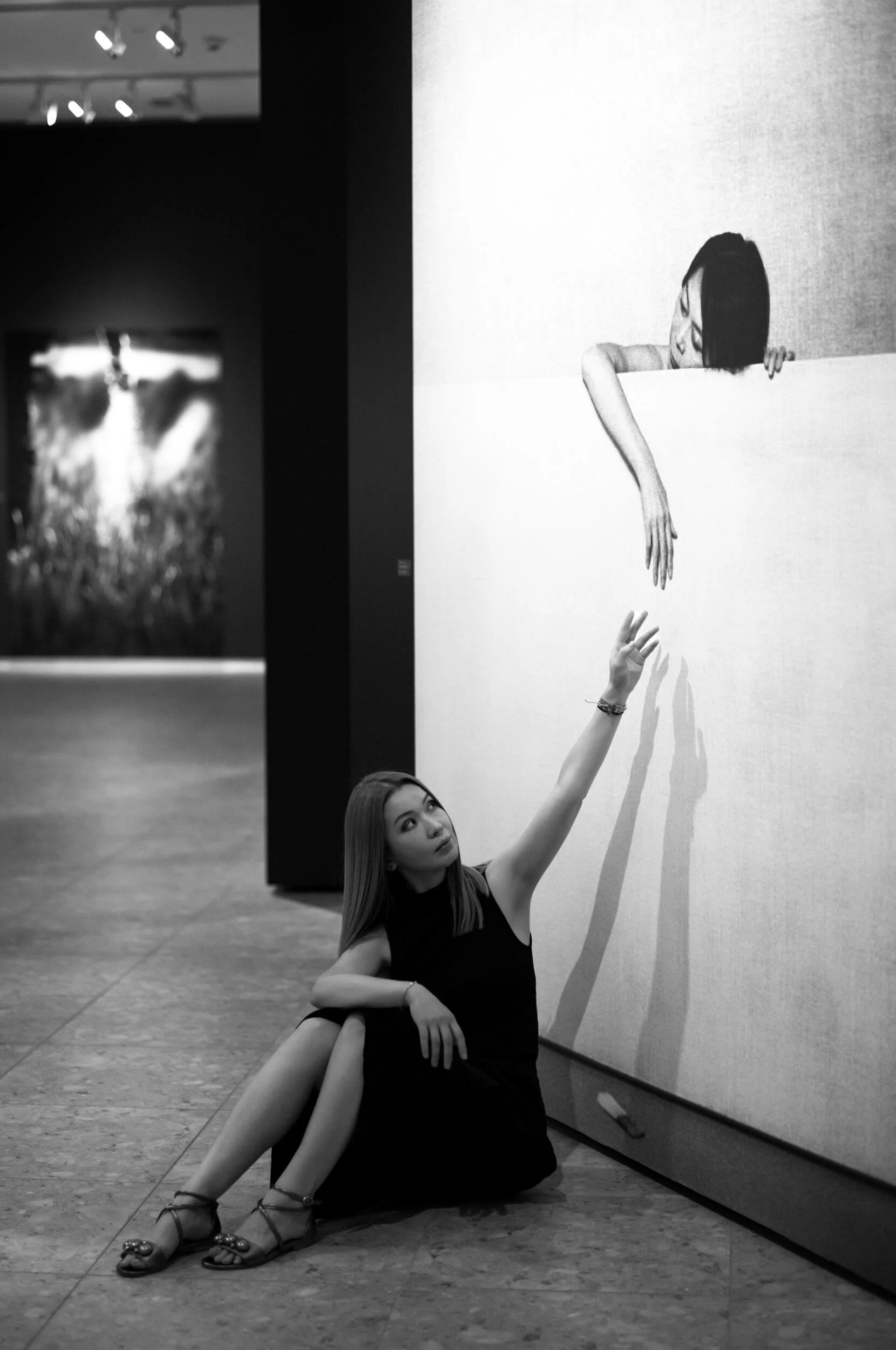 Aliya interacting with a photograph from the Donata and Wim Wenders exhibition at the Ernst Leitz Museum, photographed with the Leitz Summicron-M 66 f/2.