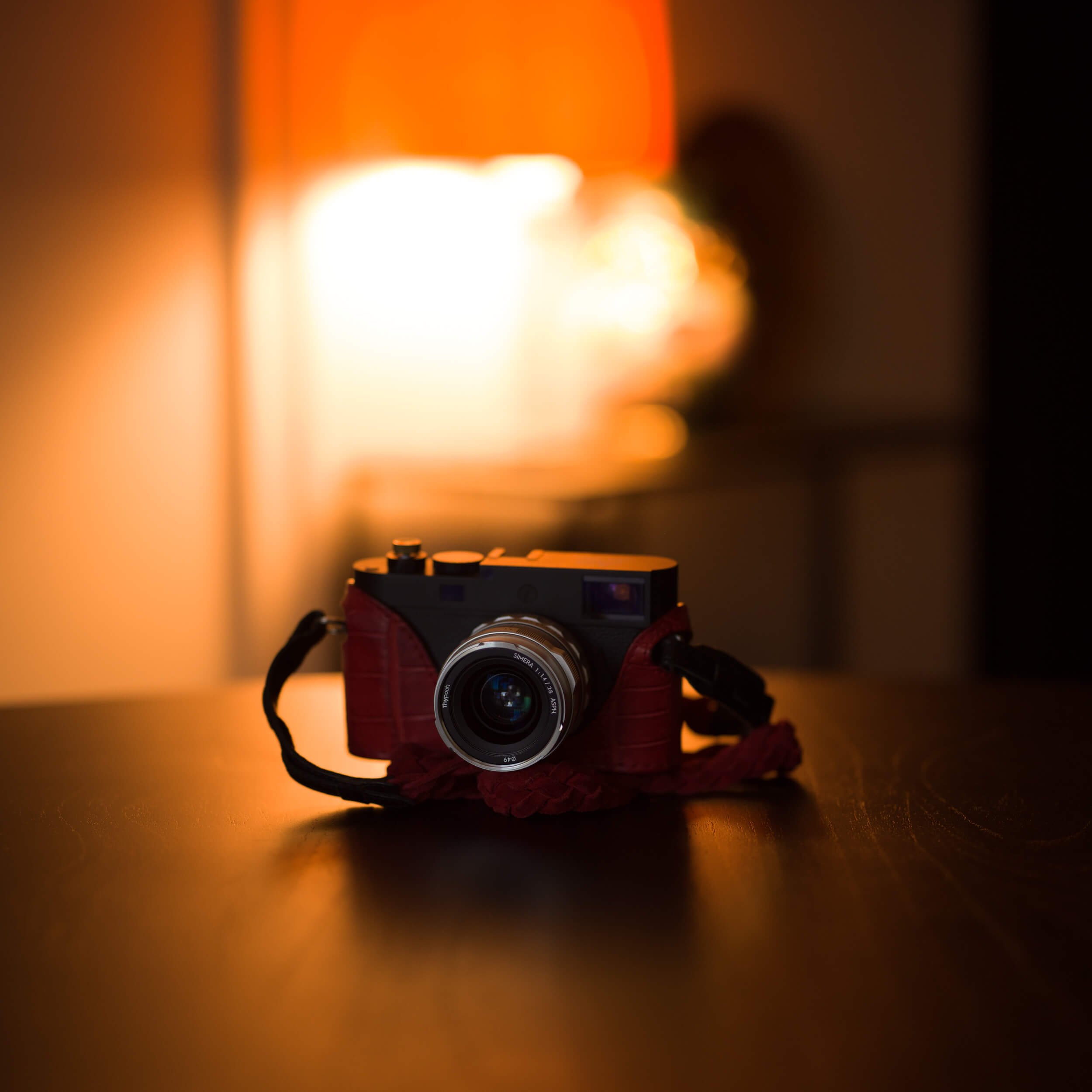 Thypoch Simera 28mm f1.4 II on Leica M11-D with Angelo Pelle red case product shot