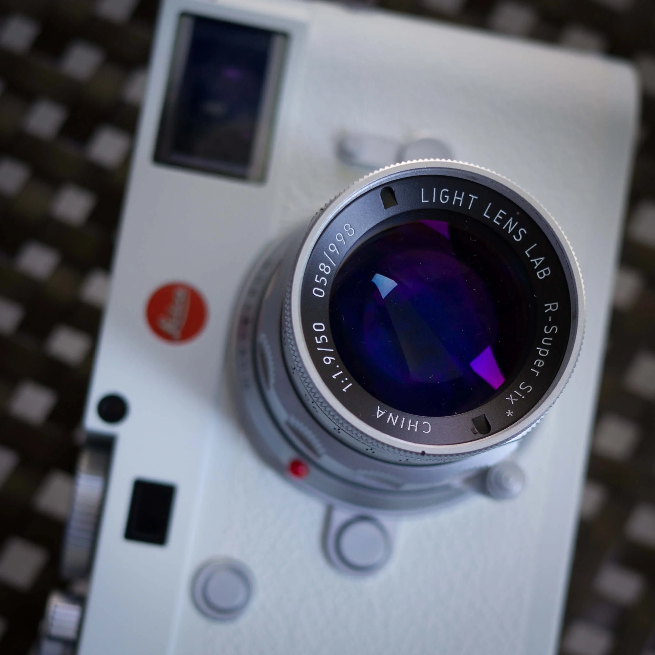 Close-up of the Light Lens Lab 50mm f/1.9 Rigid-ZS6 showing the front element and lens engraving.