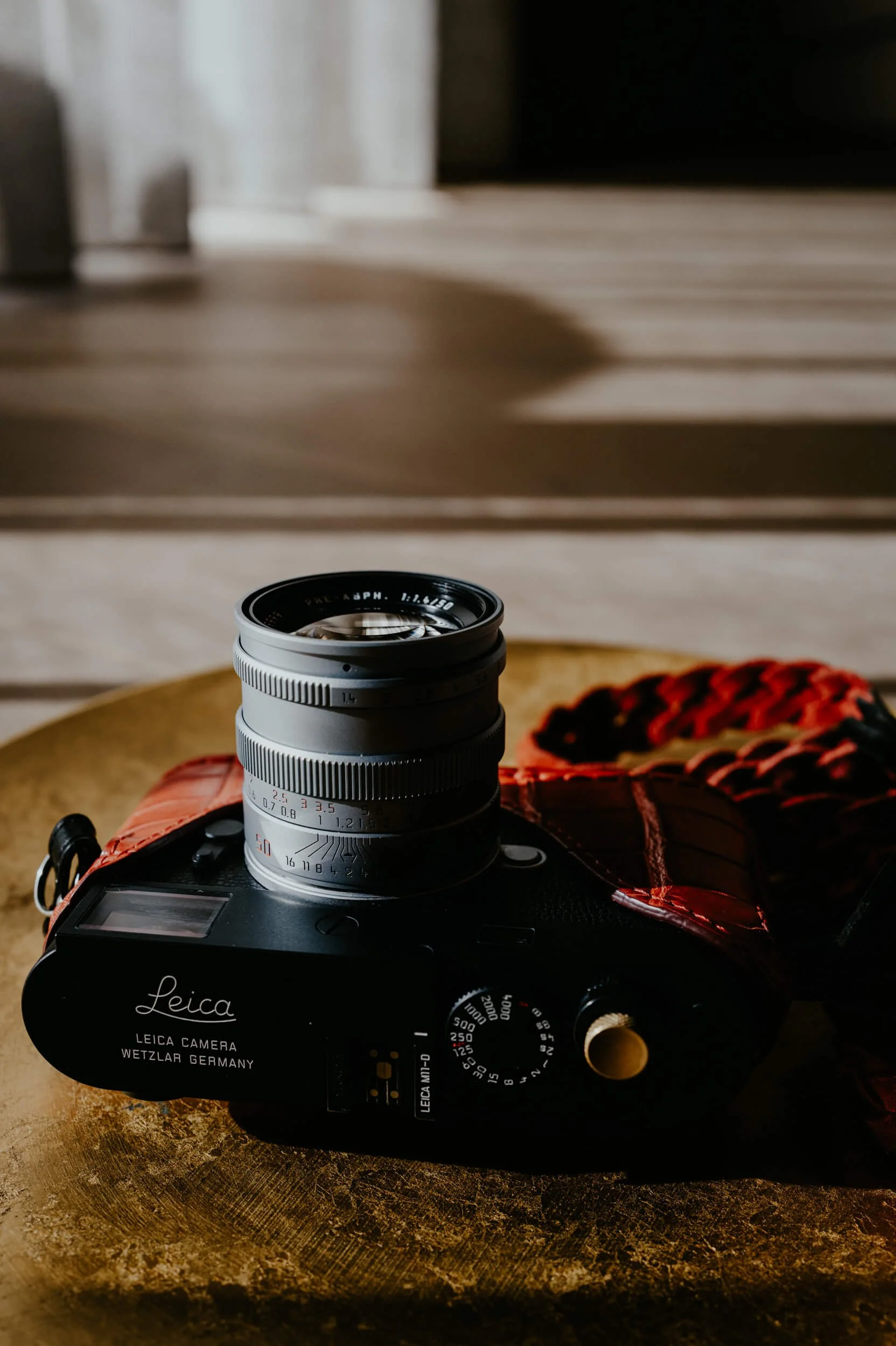 Mandler 50mm f/1.4 E46 Pre-A brass lens mounted on the Leica M11-D, showing the aperture and focusing scales.