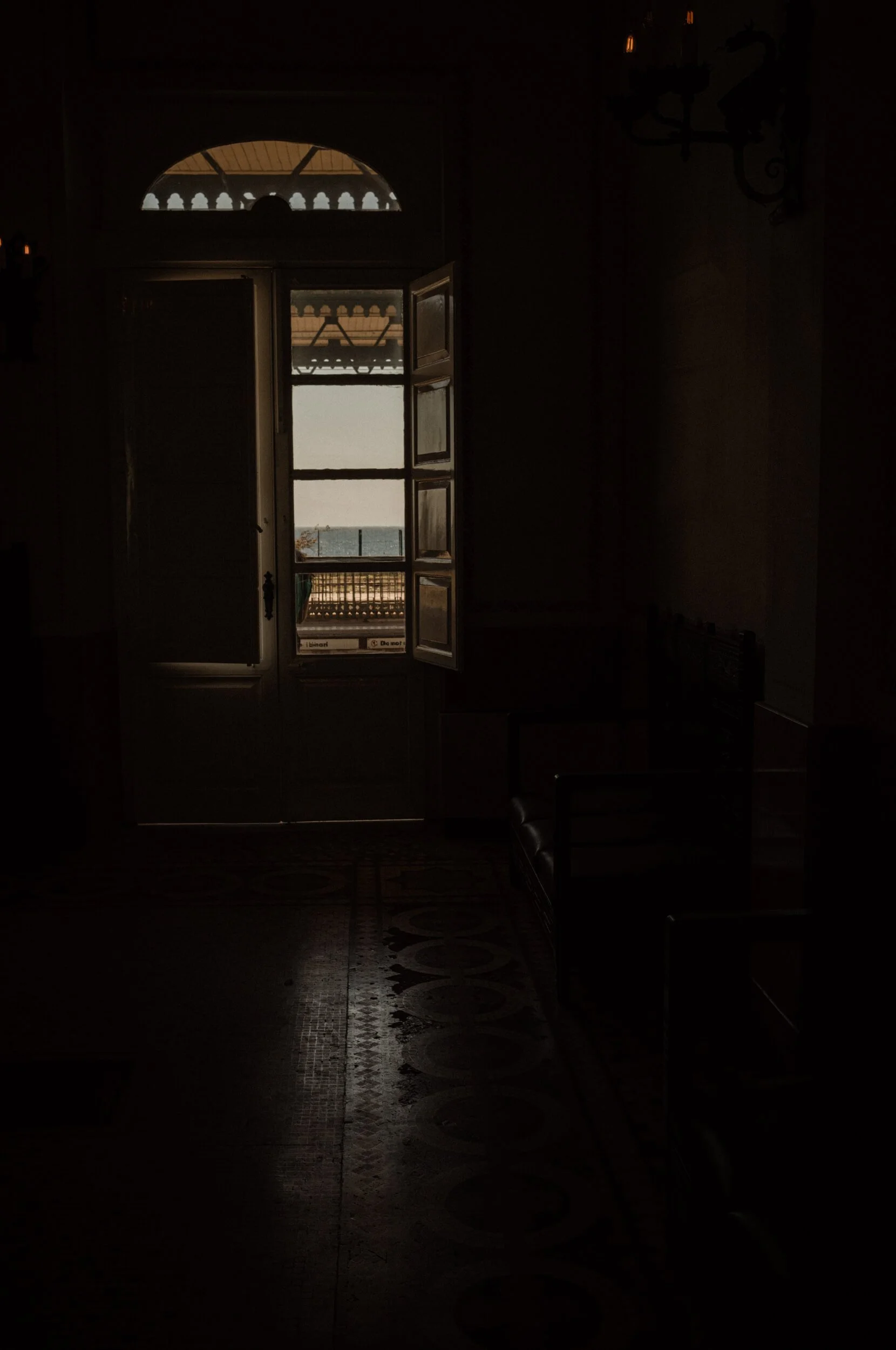 Open doorway in a historic Sicilian building overlooking the Mediterranean Sea, photographed with the Thypoch Ksana 35mm f/2.