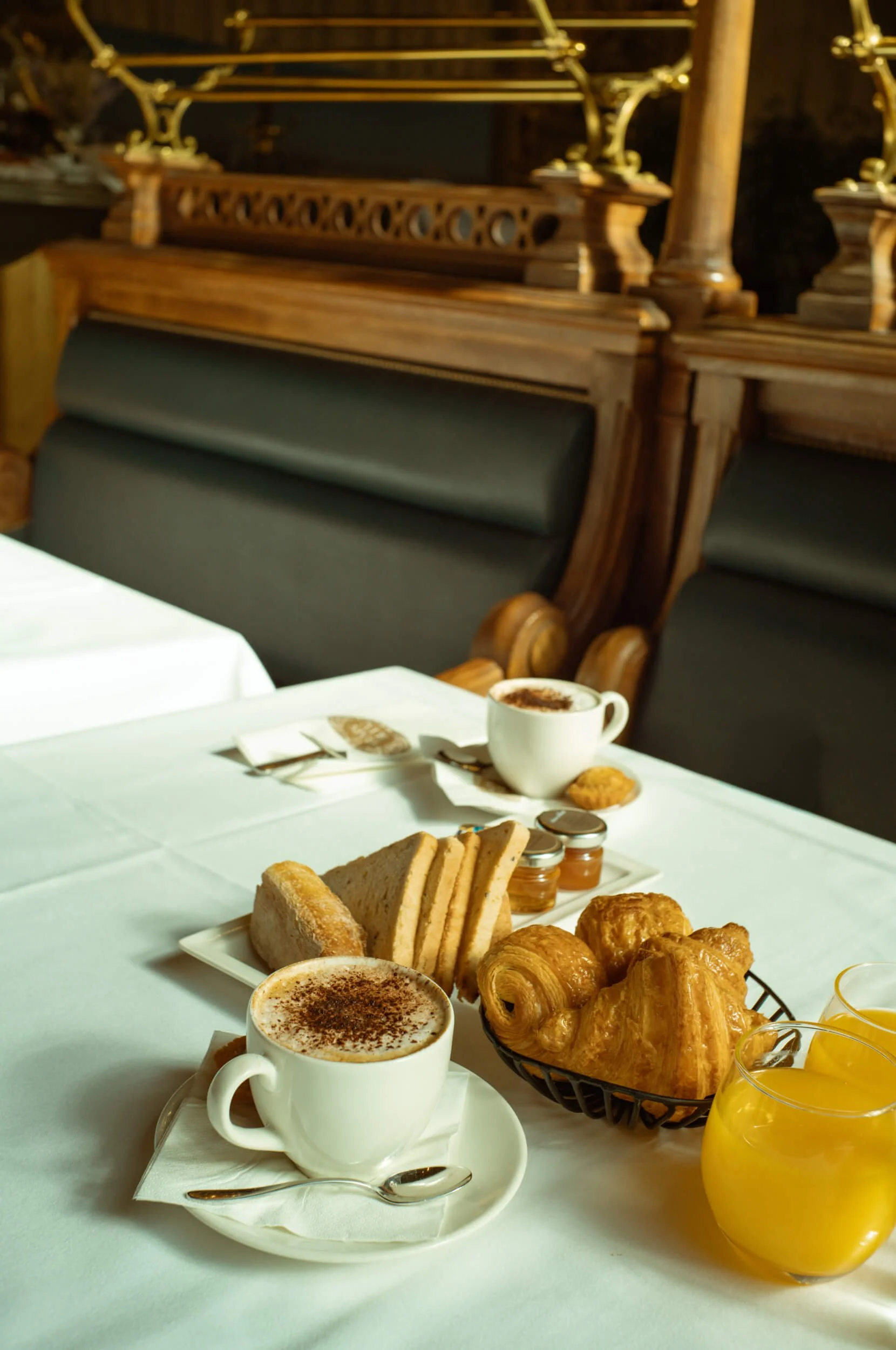 Breakfast with coffee, croissants, bread and orange juice at Le Train Bleu inside Gare de Lyon, Paris.