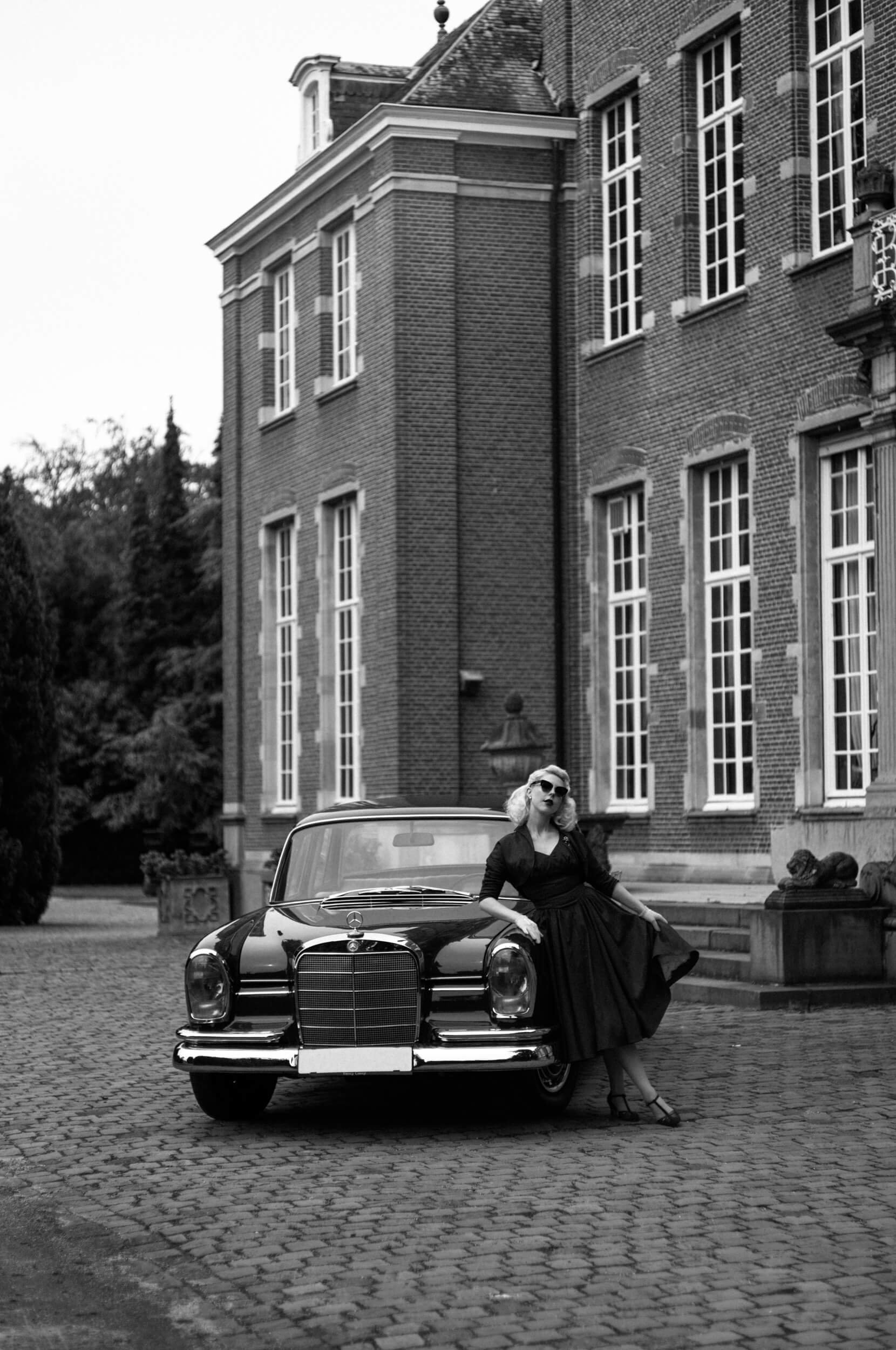 Yulia standing beside a vintage Mercedes at Kasteel Hallehof photographed with the Light Lens Lab 75mm f/1.5 Z21
