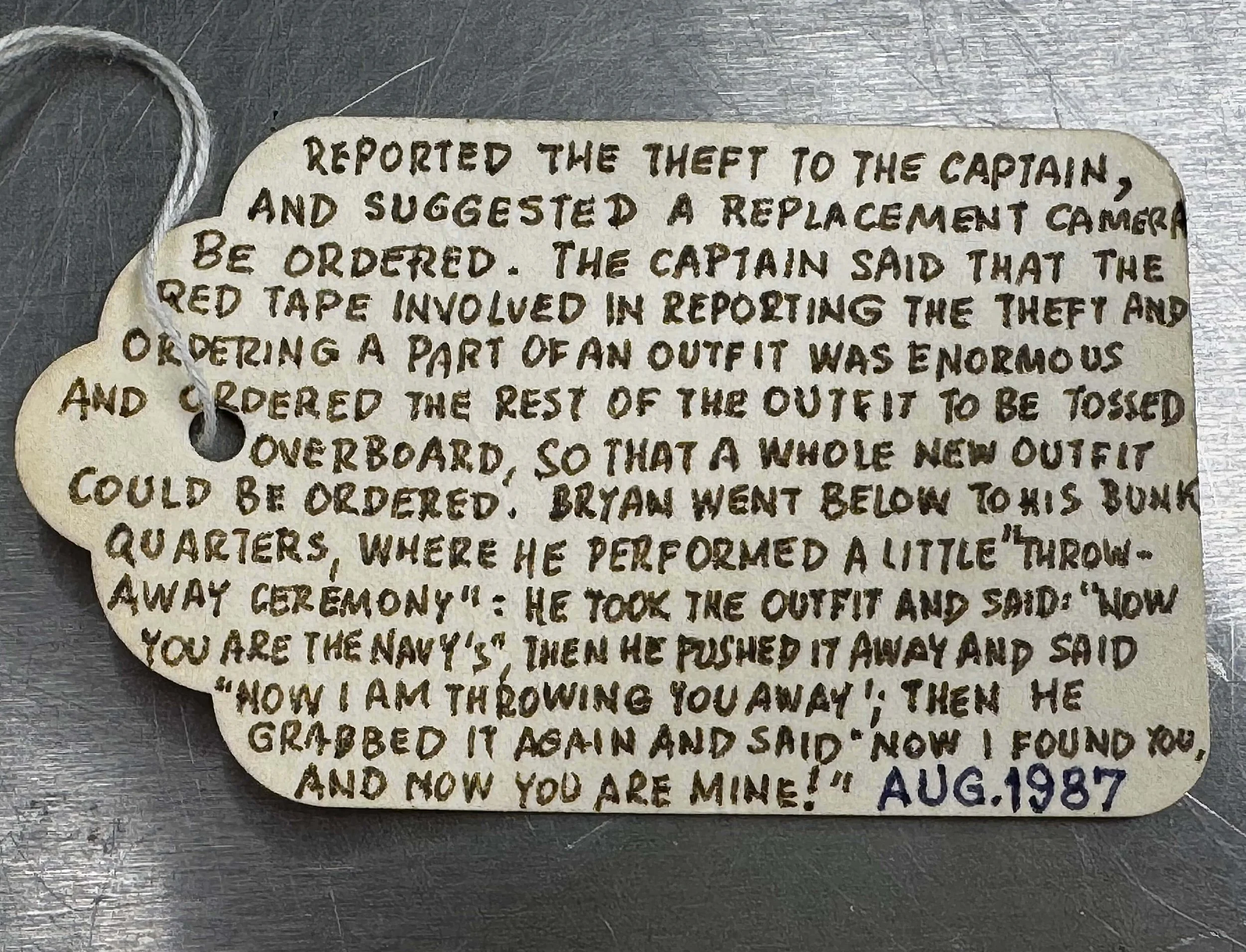 Reverse side of Rolf Fricke's handwritten provenance tag describing Bryan White's account of how the original ELCAN 66mm f/2 survived military disposal.