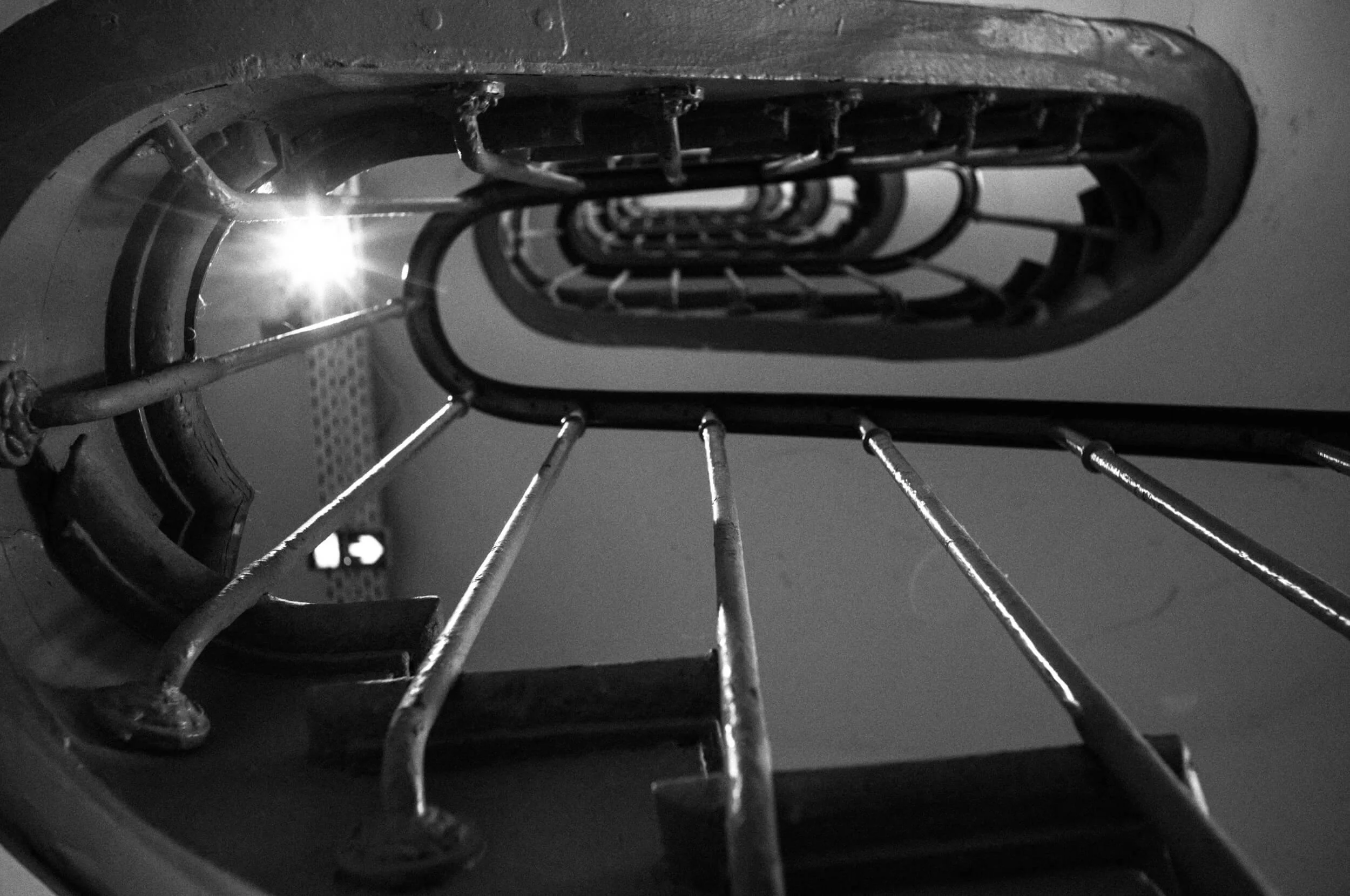Black-and-white close-up photograph of metal steps and industrial details, captured with the Leica M11 Monochrom and Mandler 35mm f/2 lens.