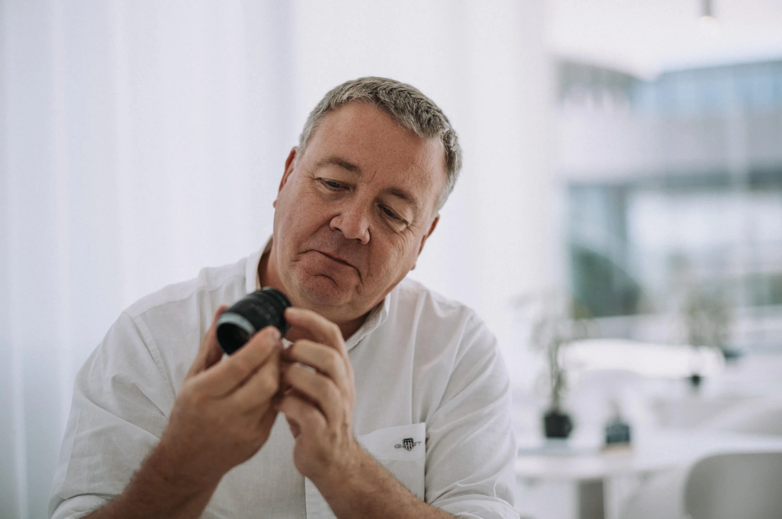 Stefan Daniel examining the new Leitz Summicron-M 66 f/2 during our conversation at the Leitz Café in Leitz Park, Wetzlar.