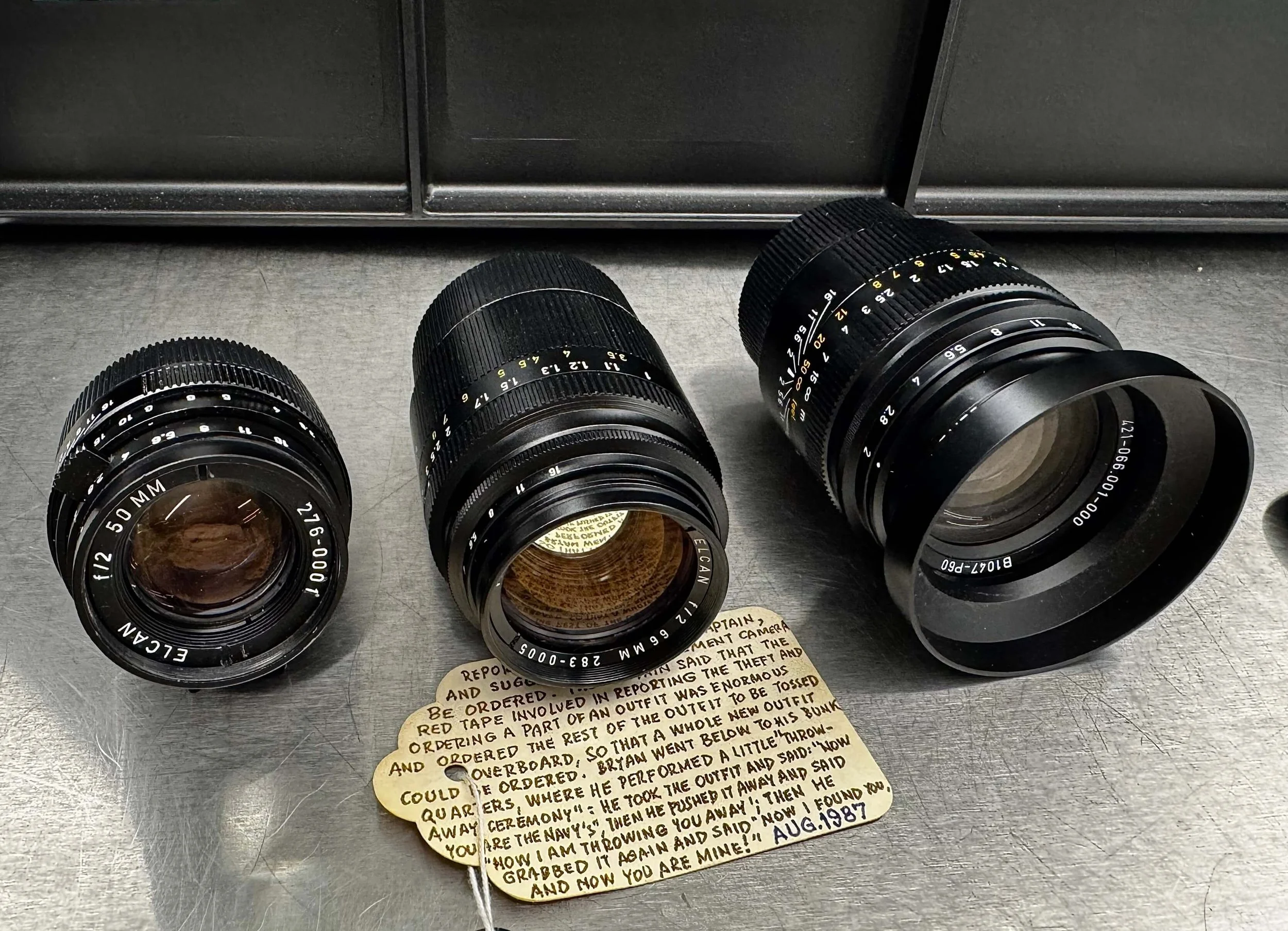 The original ELCAN 50mm, original ELCAN 66mm f/2 and the new Leitz Summicron-M 66 f/2 displayed together in the Leica Archives with Bryan White's handwritten provenance tag.
