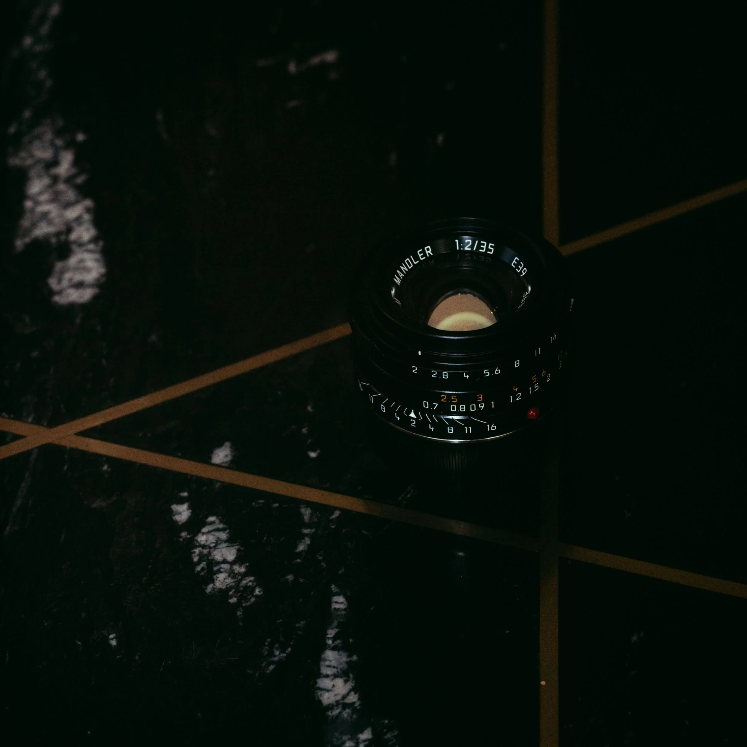 Mandler 35mm f/2 Leica M-mount lens photographed in Paris, showing the compact seven-element vintage-inspired lens design.