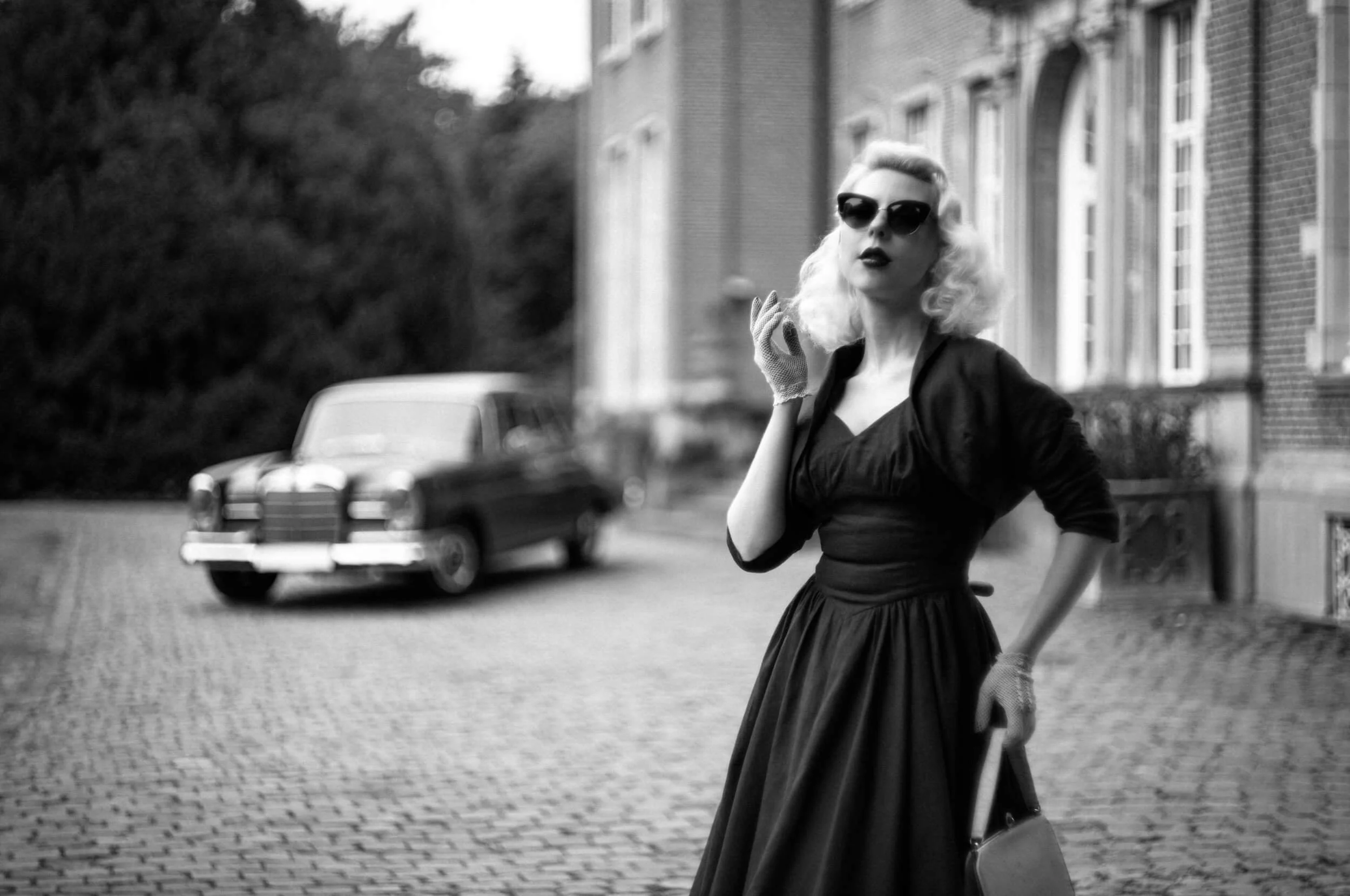 Yulia photographed in front of a vintage Mercedes with the Light Lens Lab 75mm f/1.5 Z21 on Leica M11 Monochrom