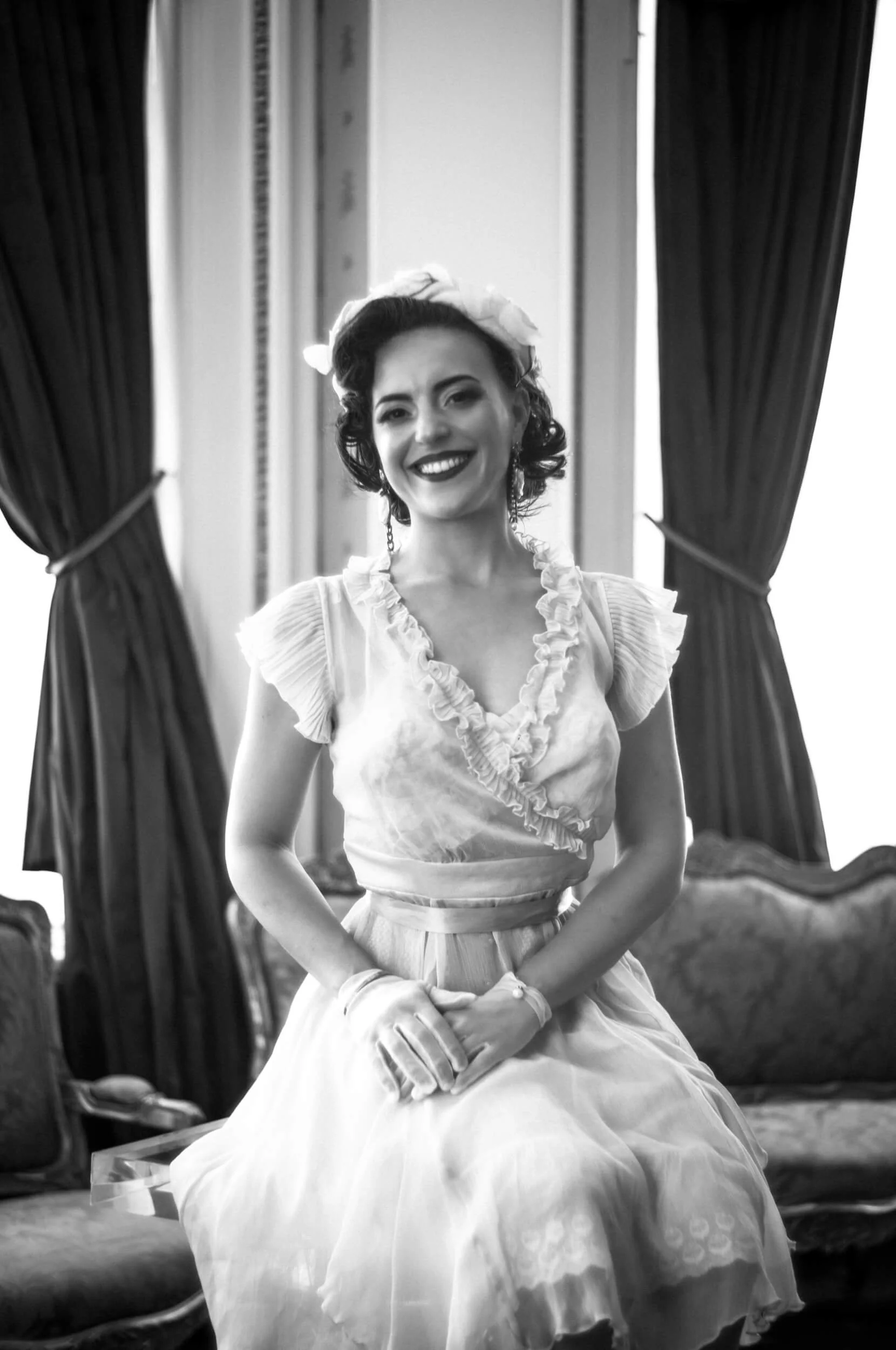 Black and white portrait of a smiling woman in vintage dress photographed with the Omnar Bertele 50mm f/2