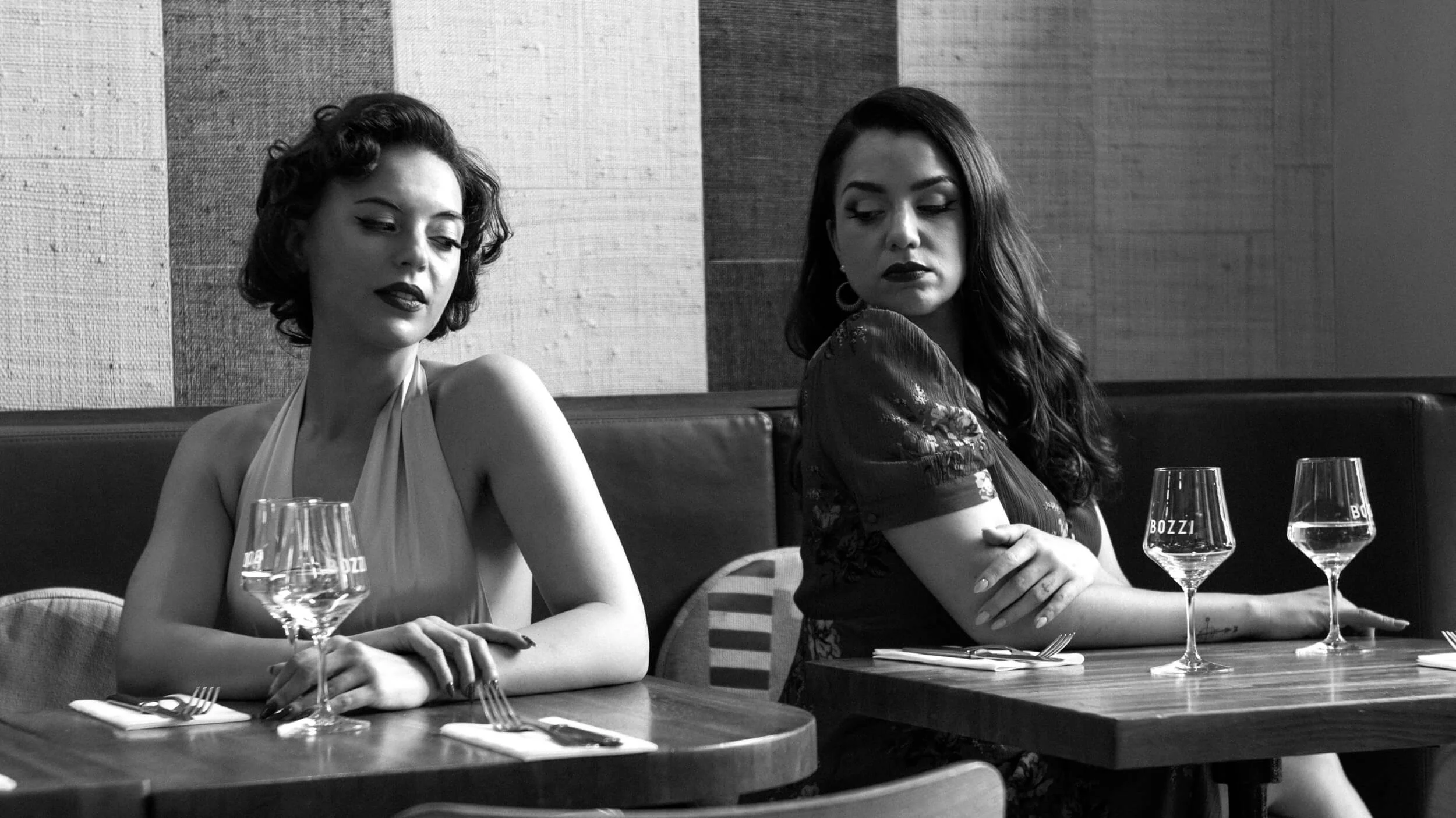 Black and white portrait of two women seated inside Café Bozzi in Nice photographed with the Omnar Bertele 50mm f/2