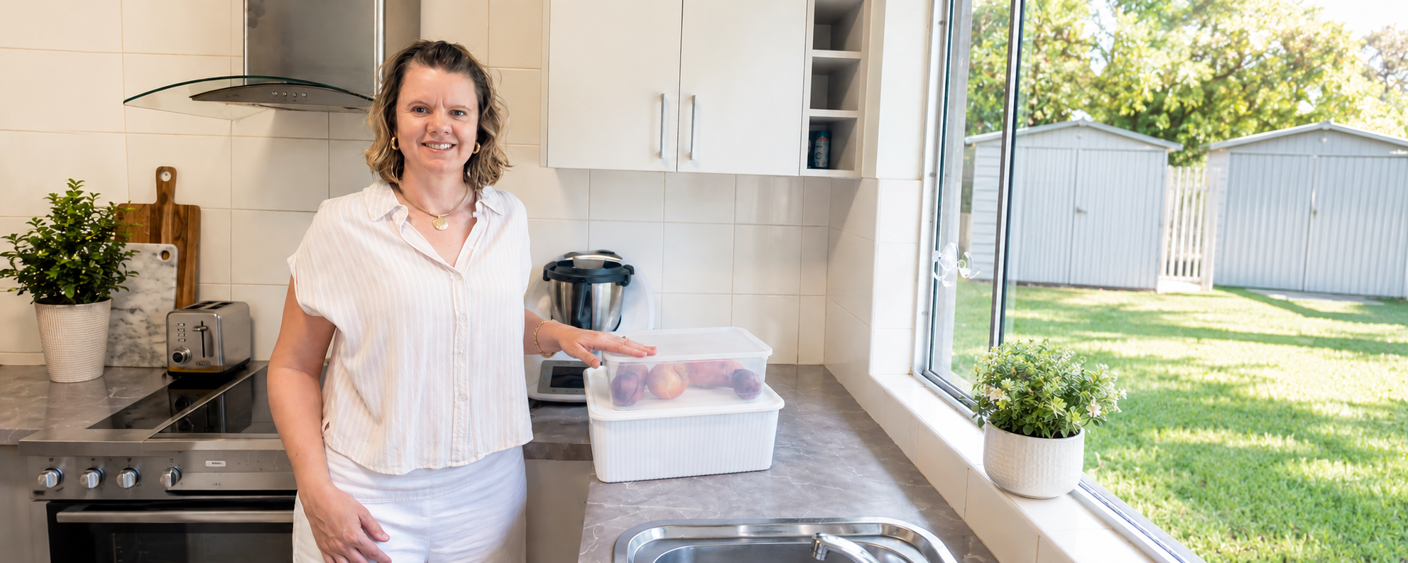 Emma in kitchen with organisation tubs