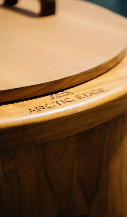 Close-up of a wooden surface with the engraved text 'ARTIC Edge' on the edge of the furniture piece.