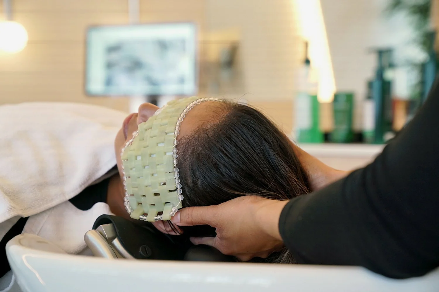 Specialist massaging a client's scalp during a head spa treatment at Cosh