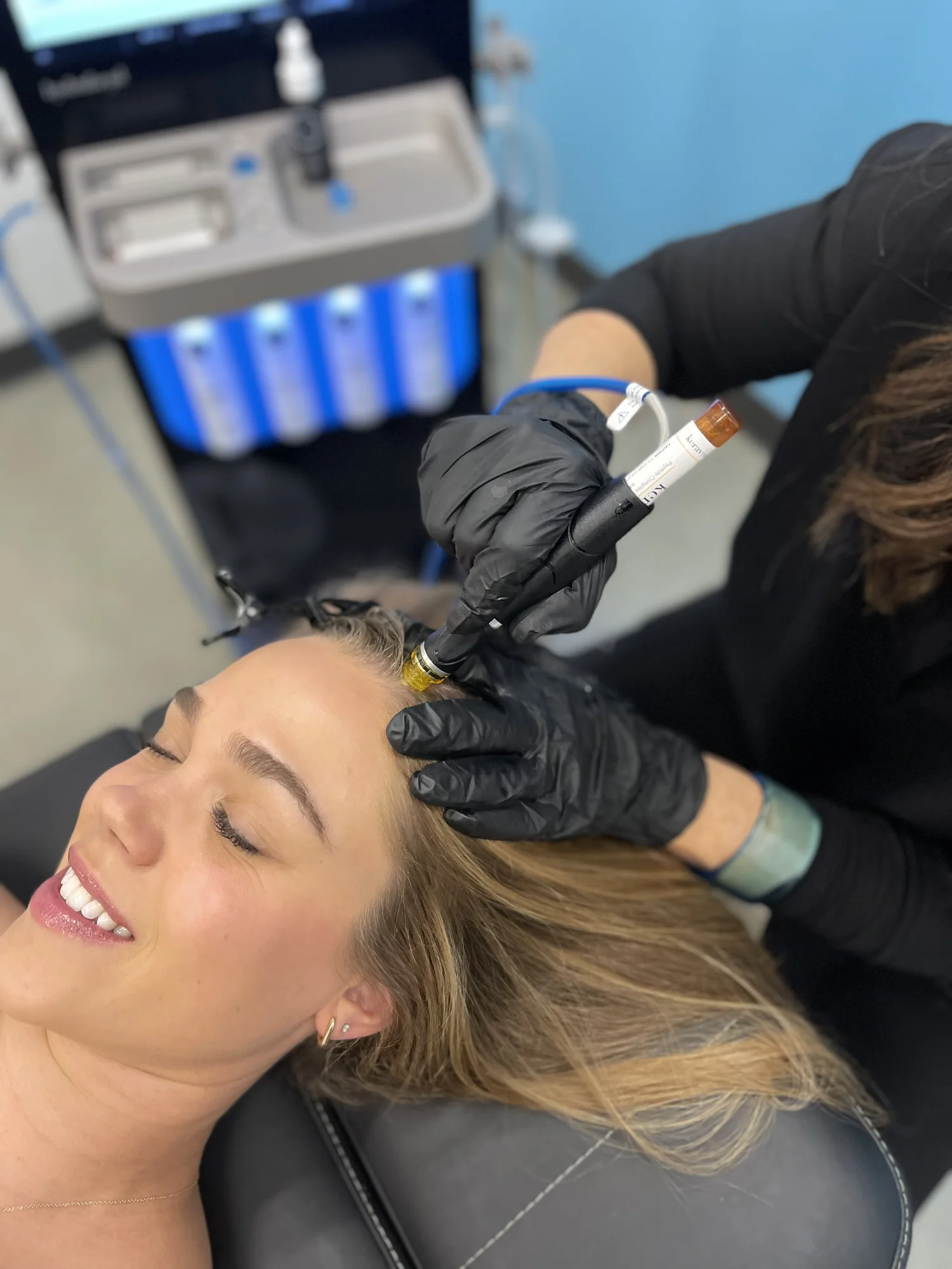 Client receiving a Hydrafacial Keravive scalp treatment at Cosh Head Spa in Burlingame