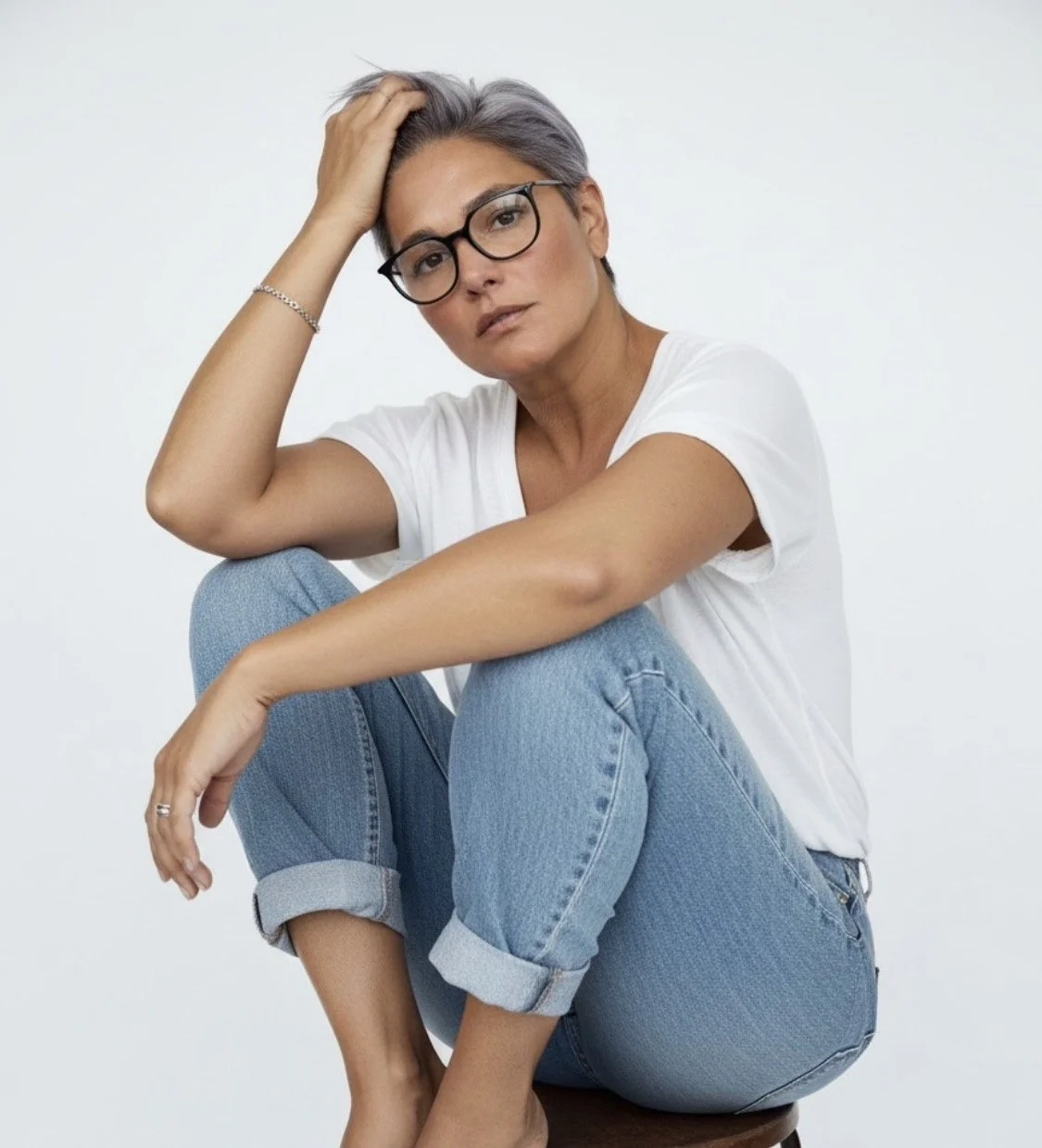 Founder, Bec Waterfield in jeans and a tshirt sitting on a stool