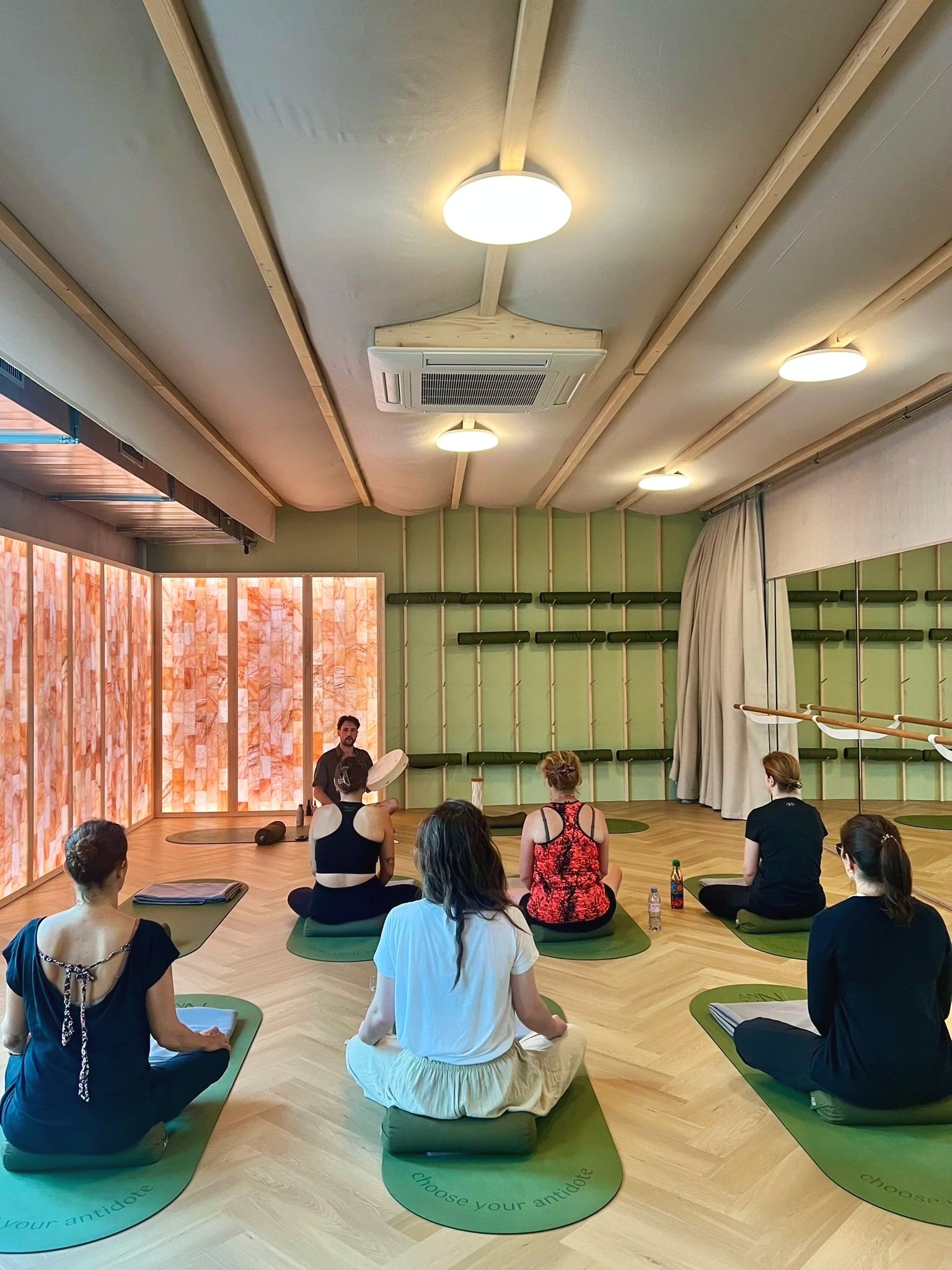Group mindfulness and breath-guided weekly session with participants seated on mats at ANNTIN Wellbeing Studio in Zurich Nord.