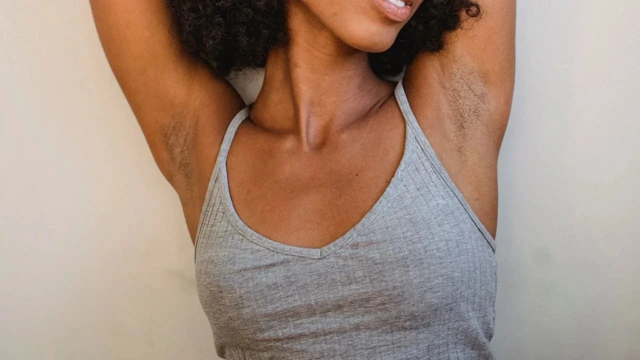 Woman with visible underarm hair growth