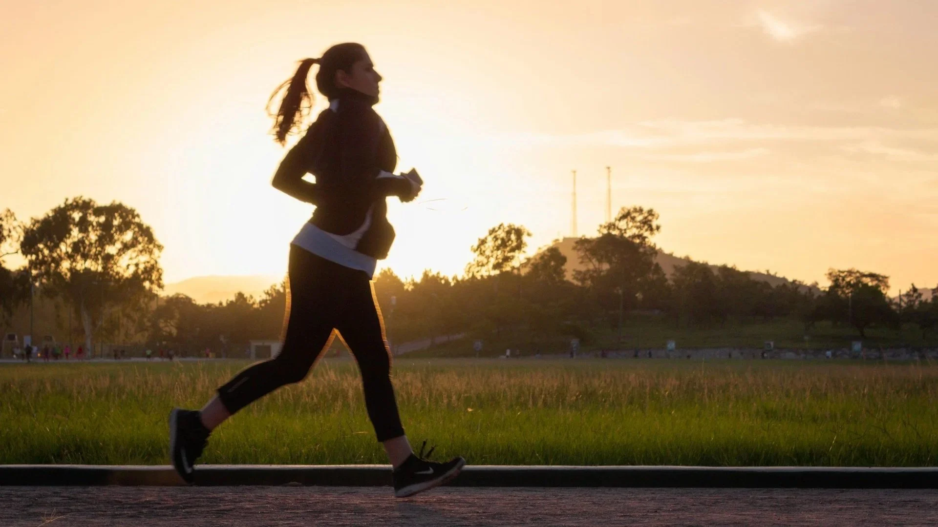 Woman jogging outdoors at sunrise