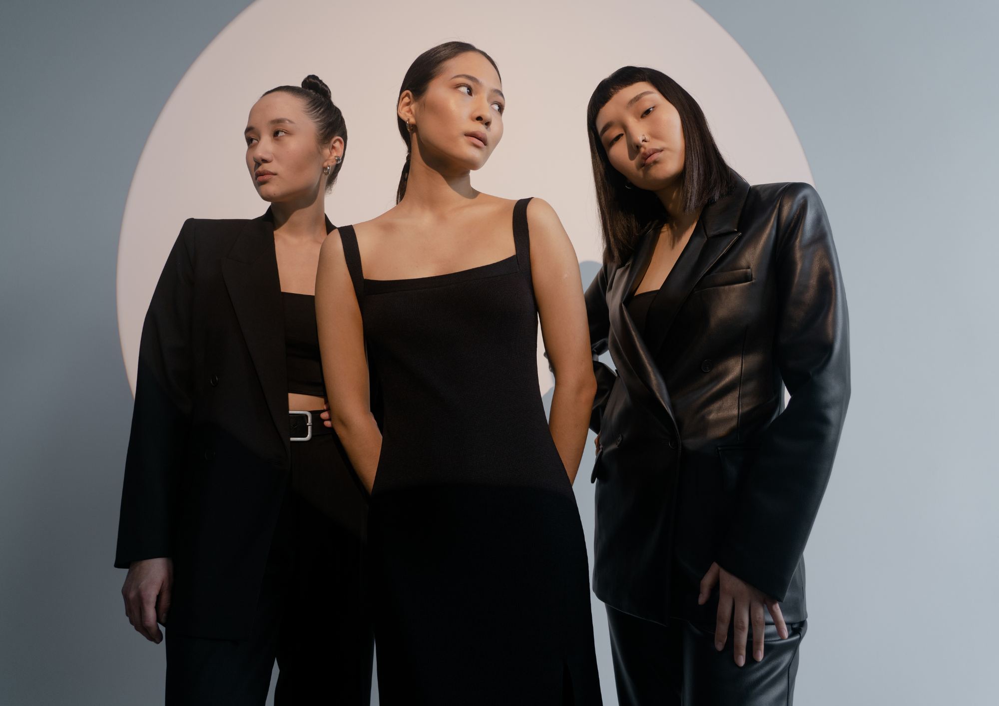 an image of three women in black stylish outfits.
