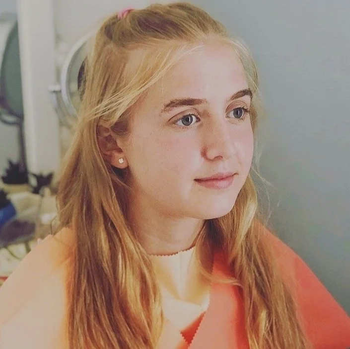 Young woman with long blonde hair and blue eyes, having her colours analysed by hello beautiful style