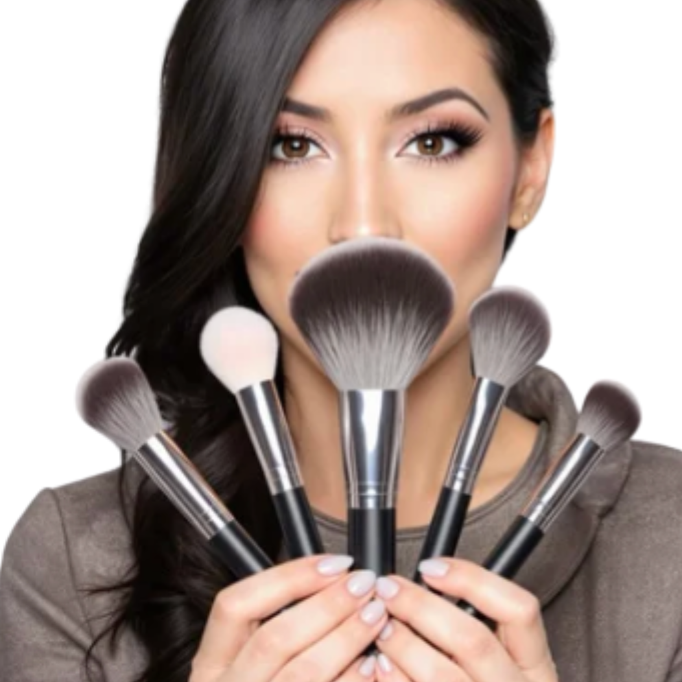 A woman with brown eyes and long dark hair holding several makeup brushes in front of her face.