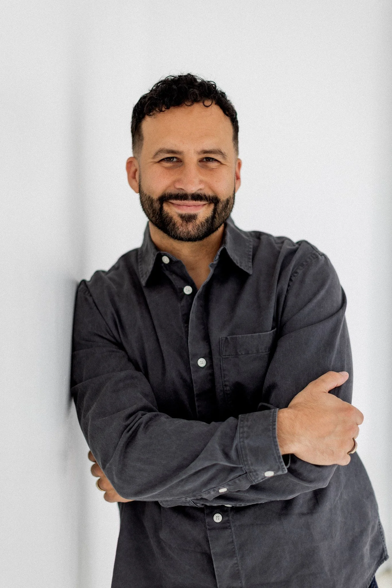 Mike Signorelli smiling in a dark gray button-up shirt.