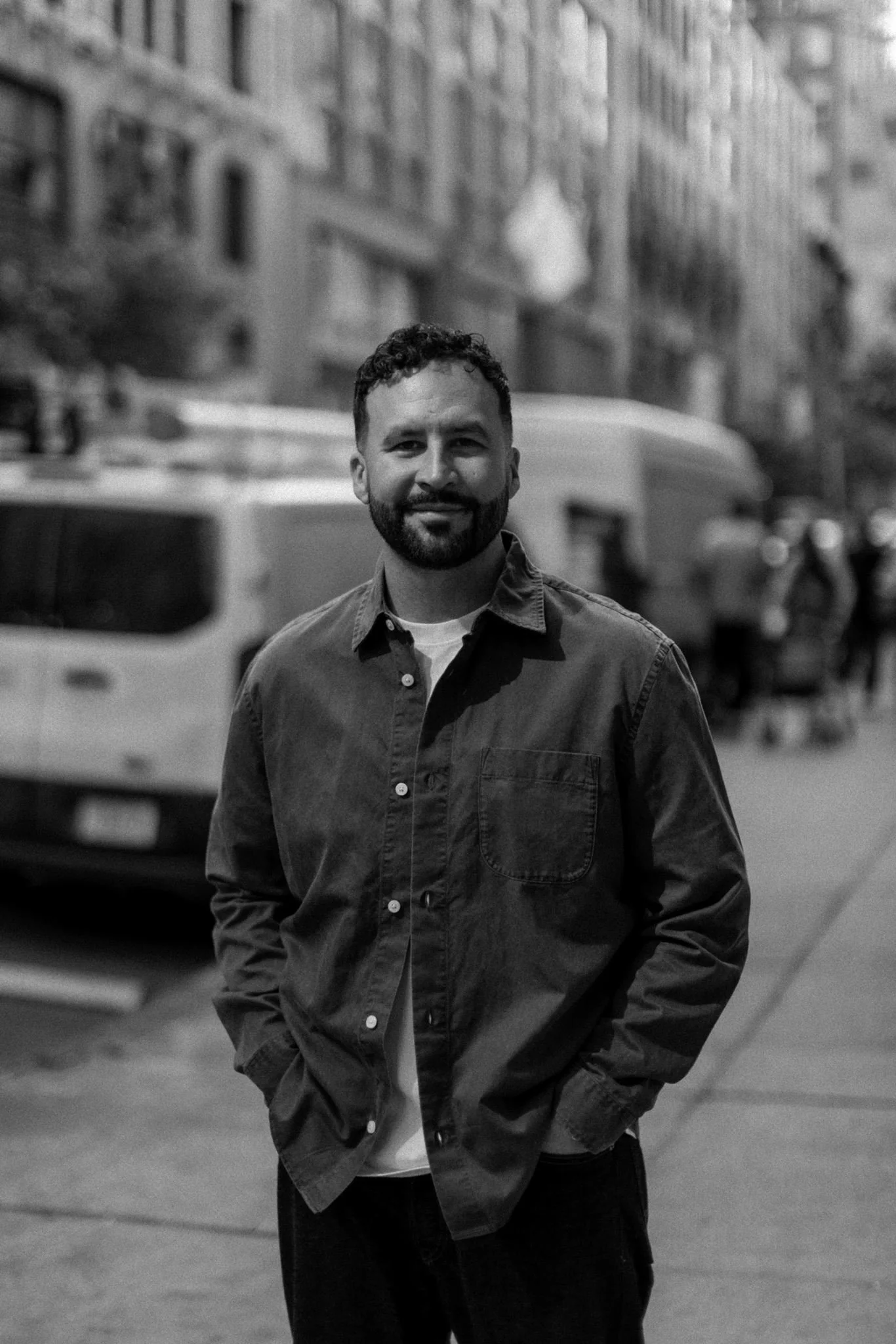 Mike Signorelli standing on a city street in a black-and-white portrait.