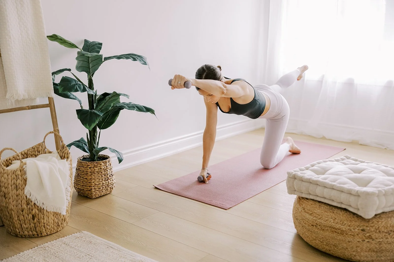 Woman practicing low impact mat Pilates weights exercises for muscle building