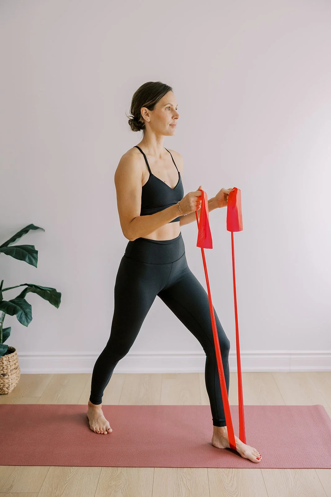 Woman doing standing lower-body strength training with a band