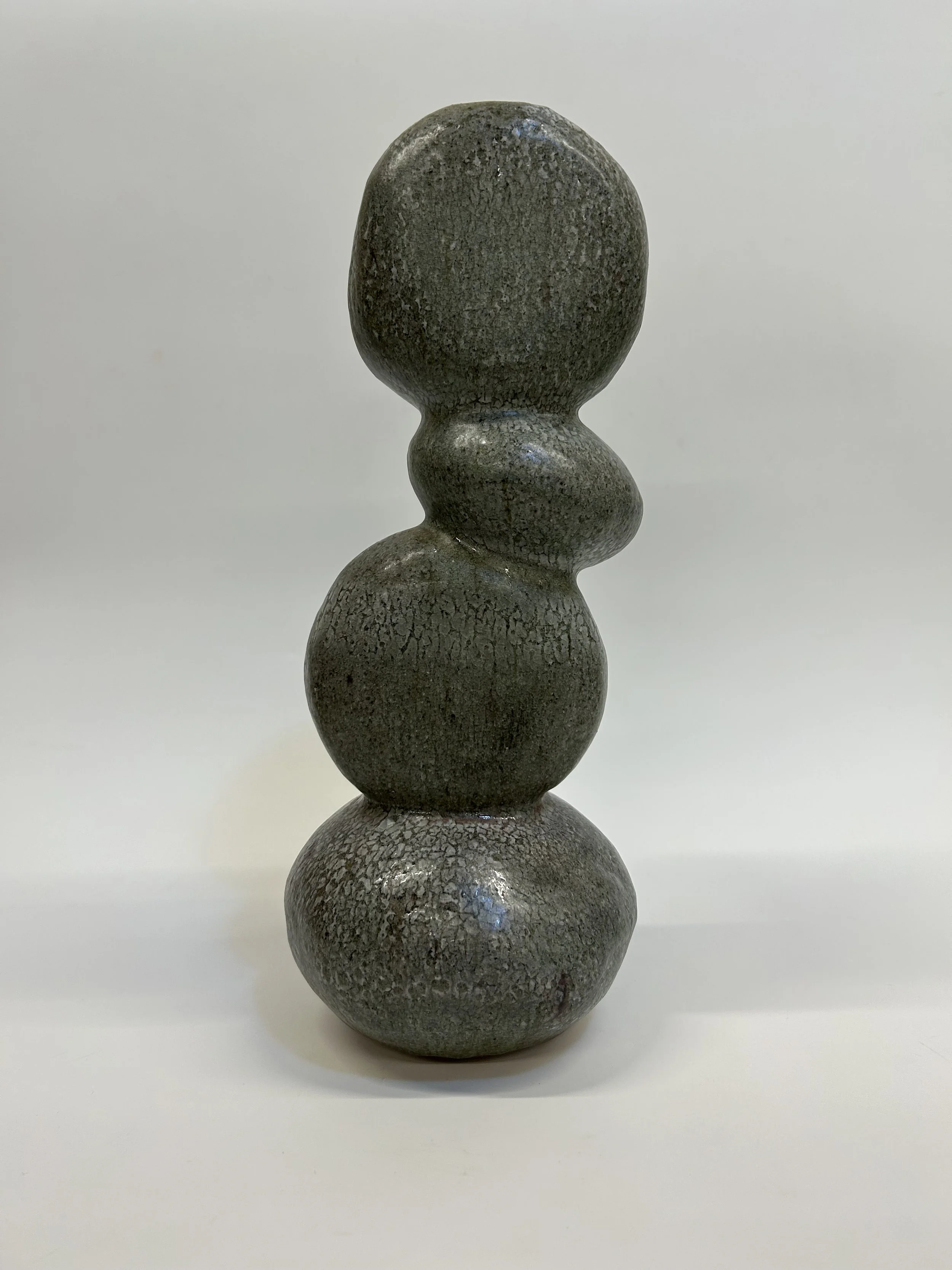 Held in Balance (2026): This piece captures the fragile steadiness found within growth and change. Layered rounded shapes rise upward with organic asymmetry, creating a rhythm that feels both grounded and fluid. The glaze recalls weathered stone shap