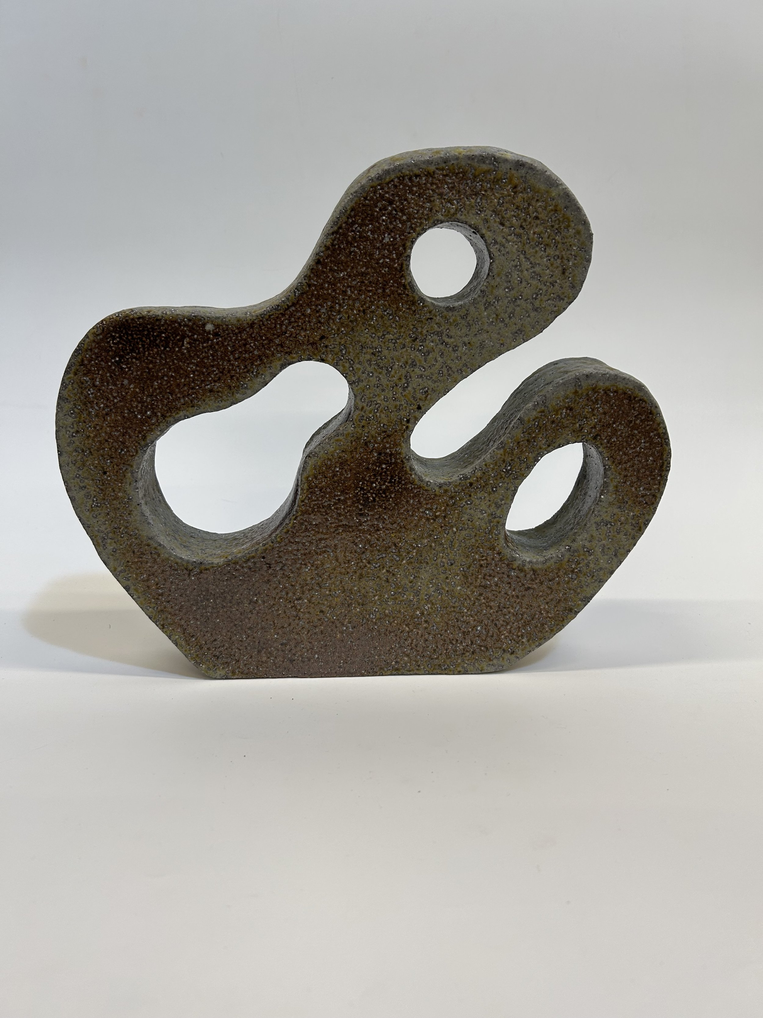Emergence (2025): This piece is very special to me as it it the first sculptural piece I made. The form reflects the act of an opening outward and upward, mirroring the carved out space for peace and transformation. This is how I feel in the clay stu