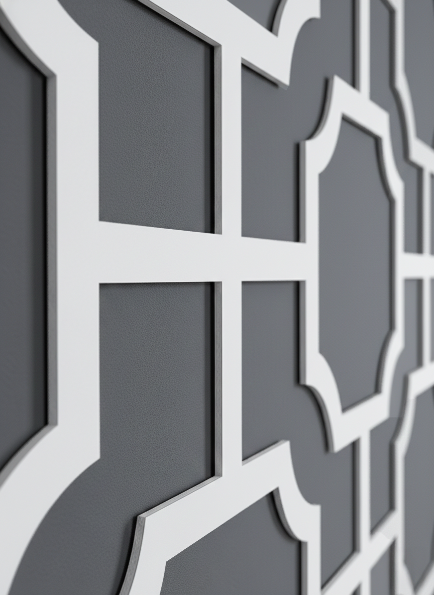 A macro detail shot of the Manhattan white expanded PVC wall panel with a geometric fretwork design.