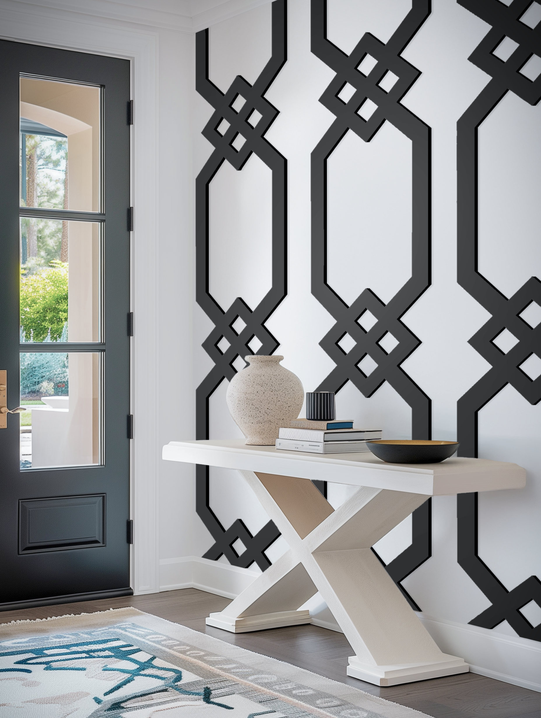 Modern entryway featuring bold black 'Truss' style geometric wall fretwork against a crisp white wall, paired with a minimalist console table.