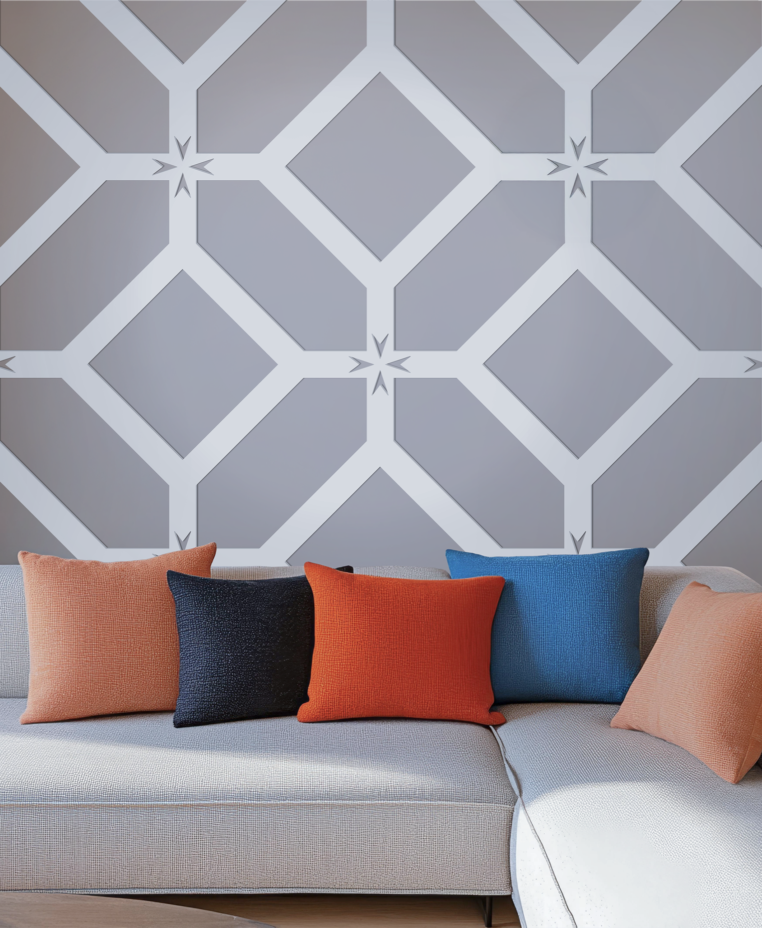 White Kass panel geometric star wall panel behind modern sectional sofa with orange, blue, and black throw pillows, sculptural luxury wall decor.