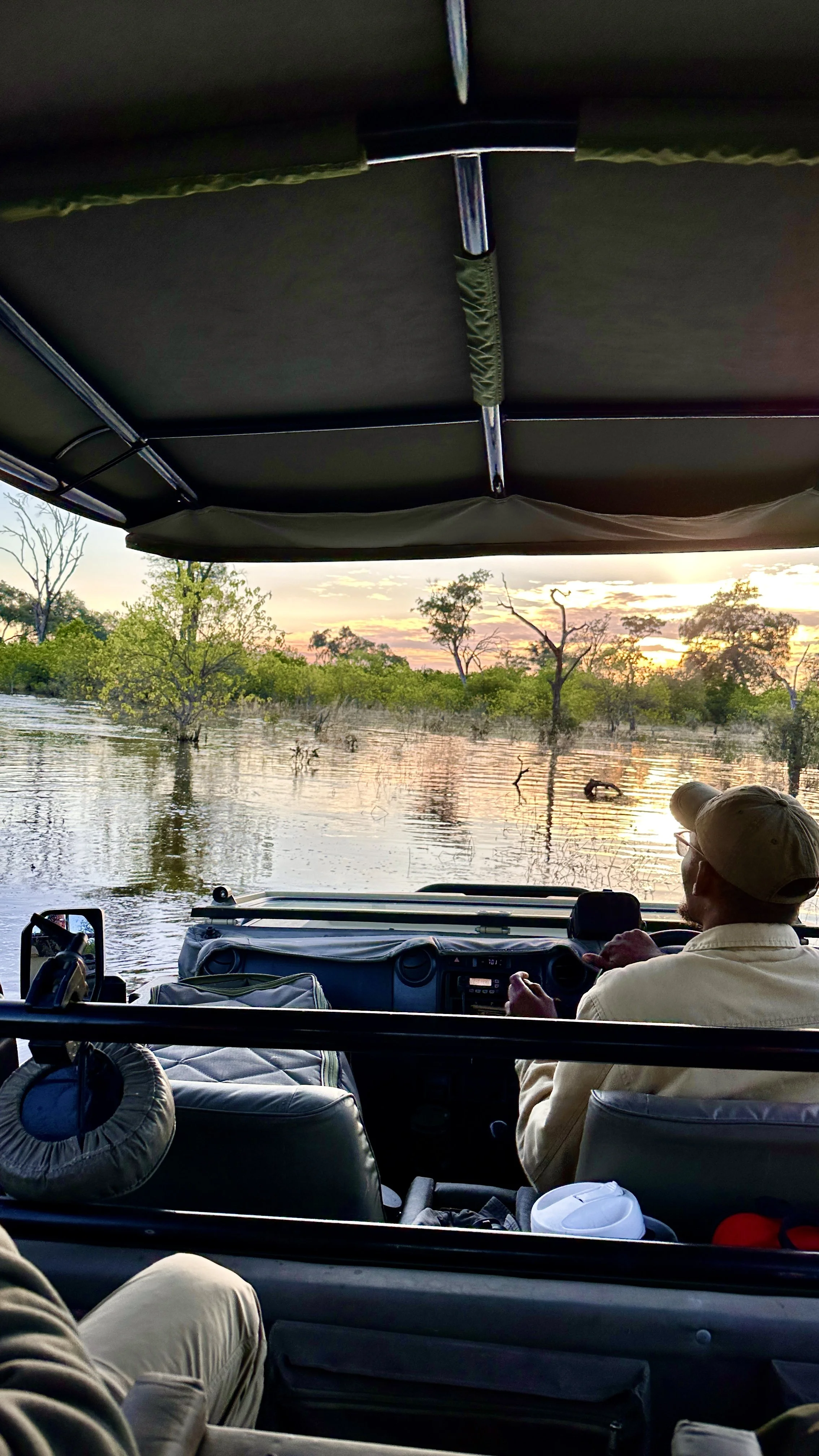 Safari vehicle crossing flooded tracks in Khwai Private Reserve