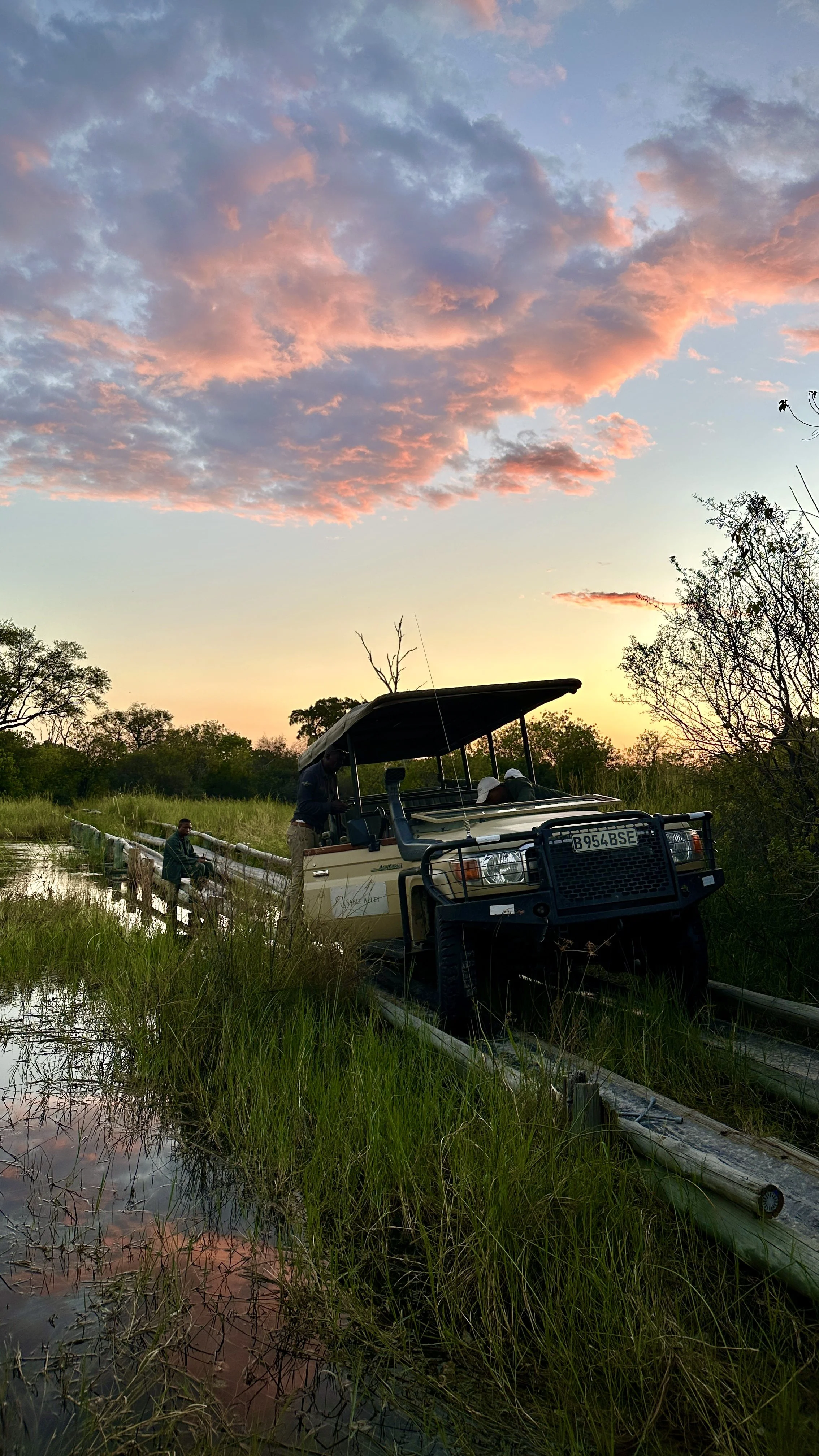 Safari vehicle stranded at a damaged bridge in flooded Khwai