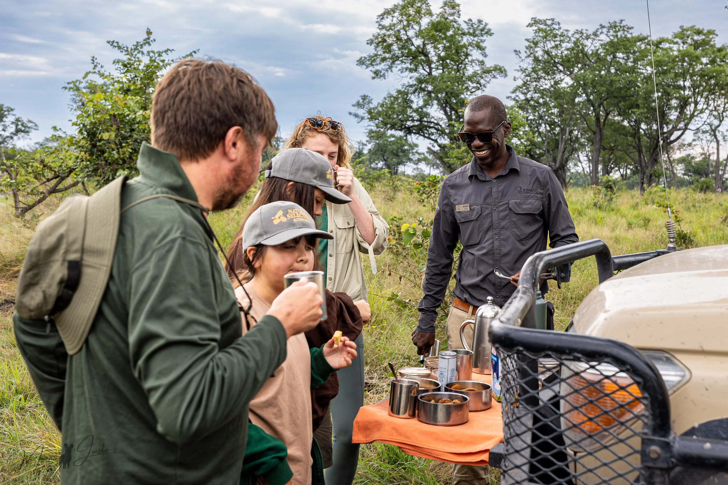 WildLens guests and local guides on safari in Khwai Private Reserve