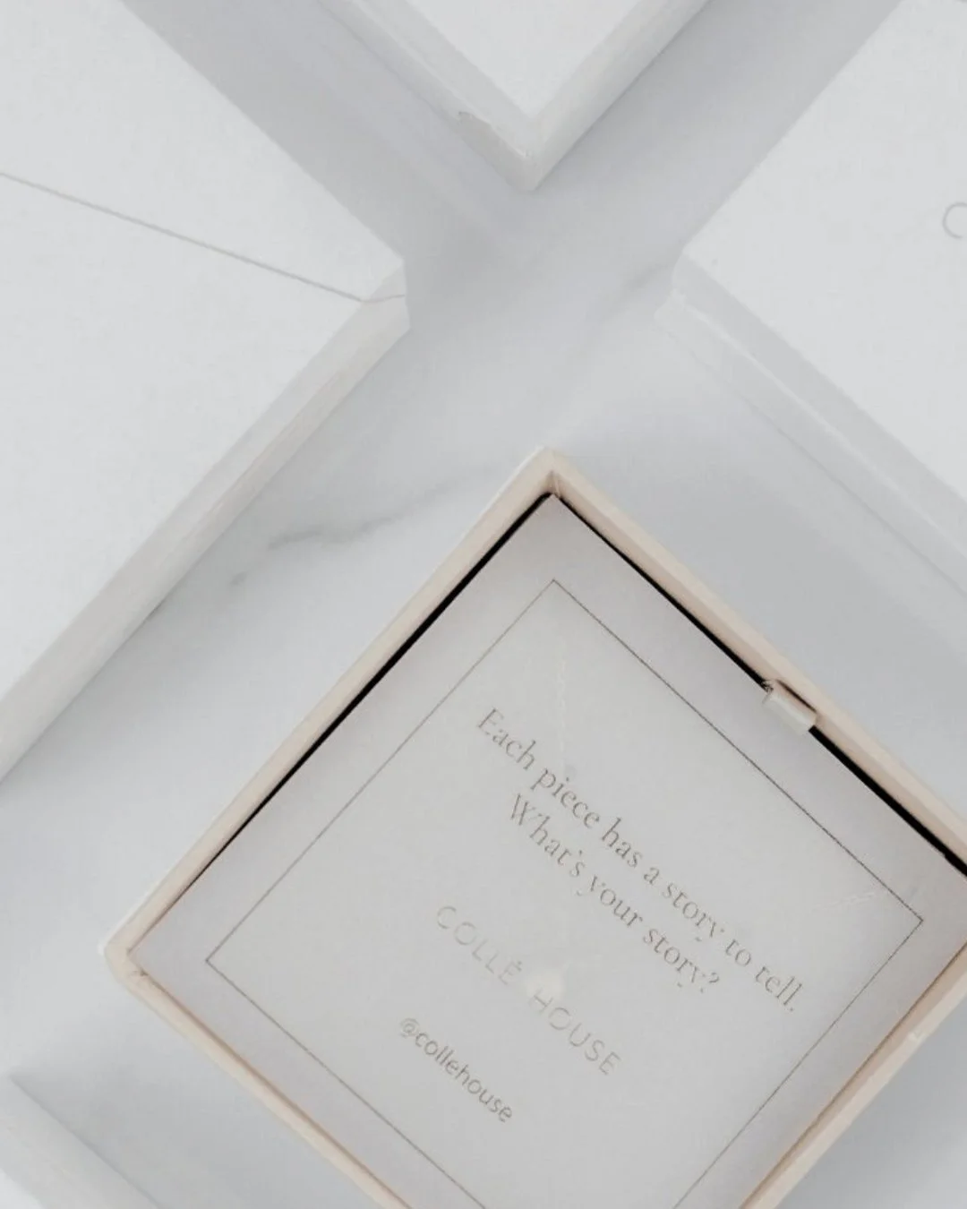 Luxury chocolate boxes, one opened to reveal a note reading “Each piece has a story to tell. What is your story?”, representing the world of pre-loved items and their unique histories