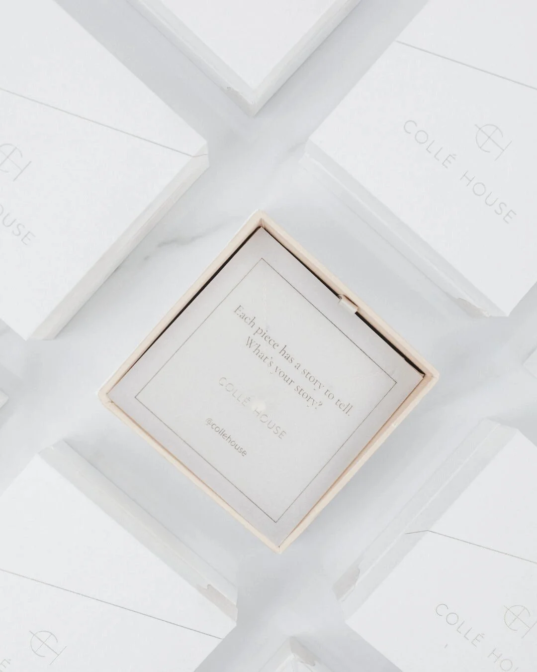 Luxury chocolate boxes, one opened to reveal a note reading “Each piece has a story to tell. What is your story?”, representing the world of pre-loved items and their unique histories