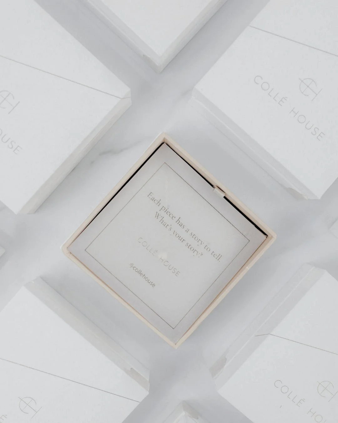 Luxury chocolate boxes, one opened to reveal a note reading “Each piece has a story to tell. What is your story?”, representing the world of pre-loved items and their unique histories