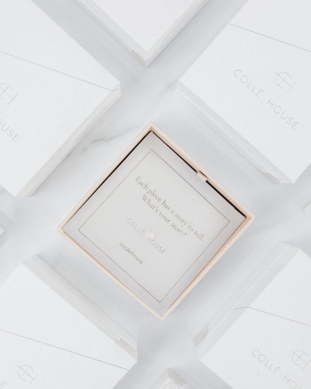 Luxury chocolate boxes, one opened to reveal a note reading “Each piece has a story to tell. What is your story?”, representing the world of pre-loved items and their unique histories
