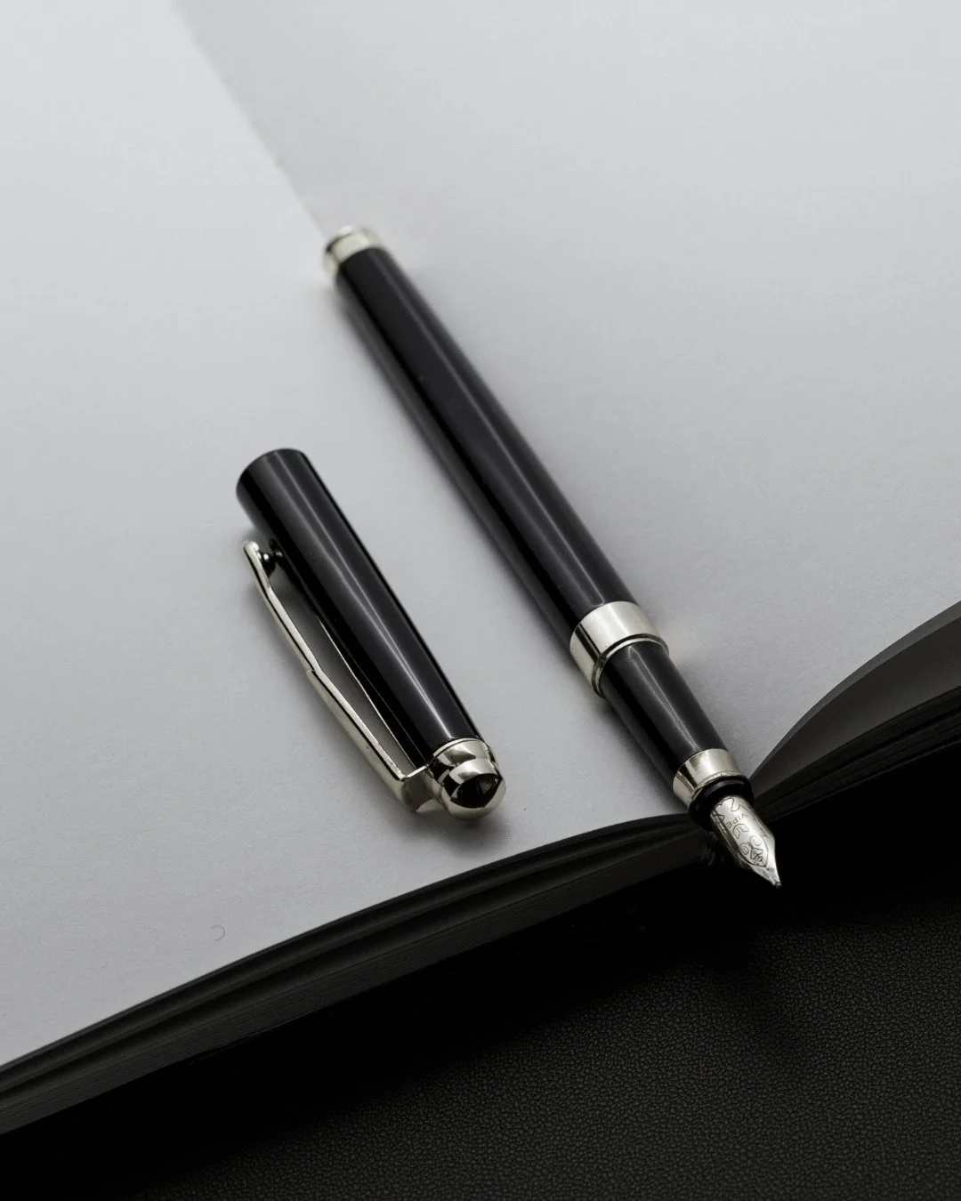 Fountain pen on an open notebook representing luxury market knowledge and long-term collection value