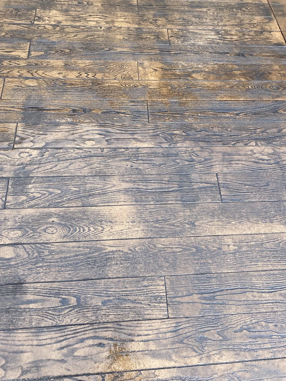 Concrete wood stamp creating a weathered, rustic appearance.