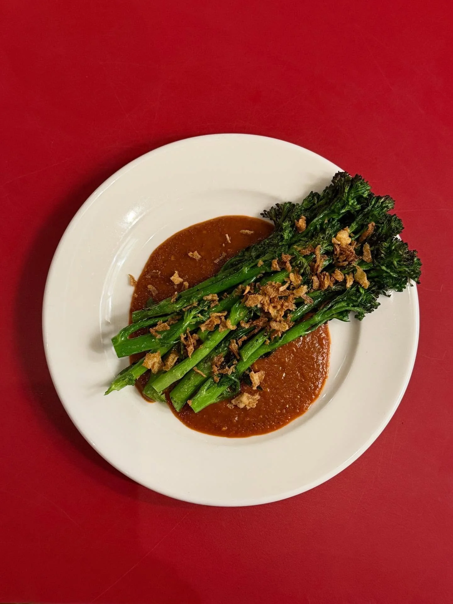 Veg done right - BBQ Tenderstem Broccoli served on top of Mojo Pico sauce and topped with crispy garlic 

The smokey red pepper sauce with a kick compliments the green crunch of broccoli 🥦