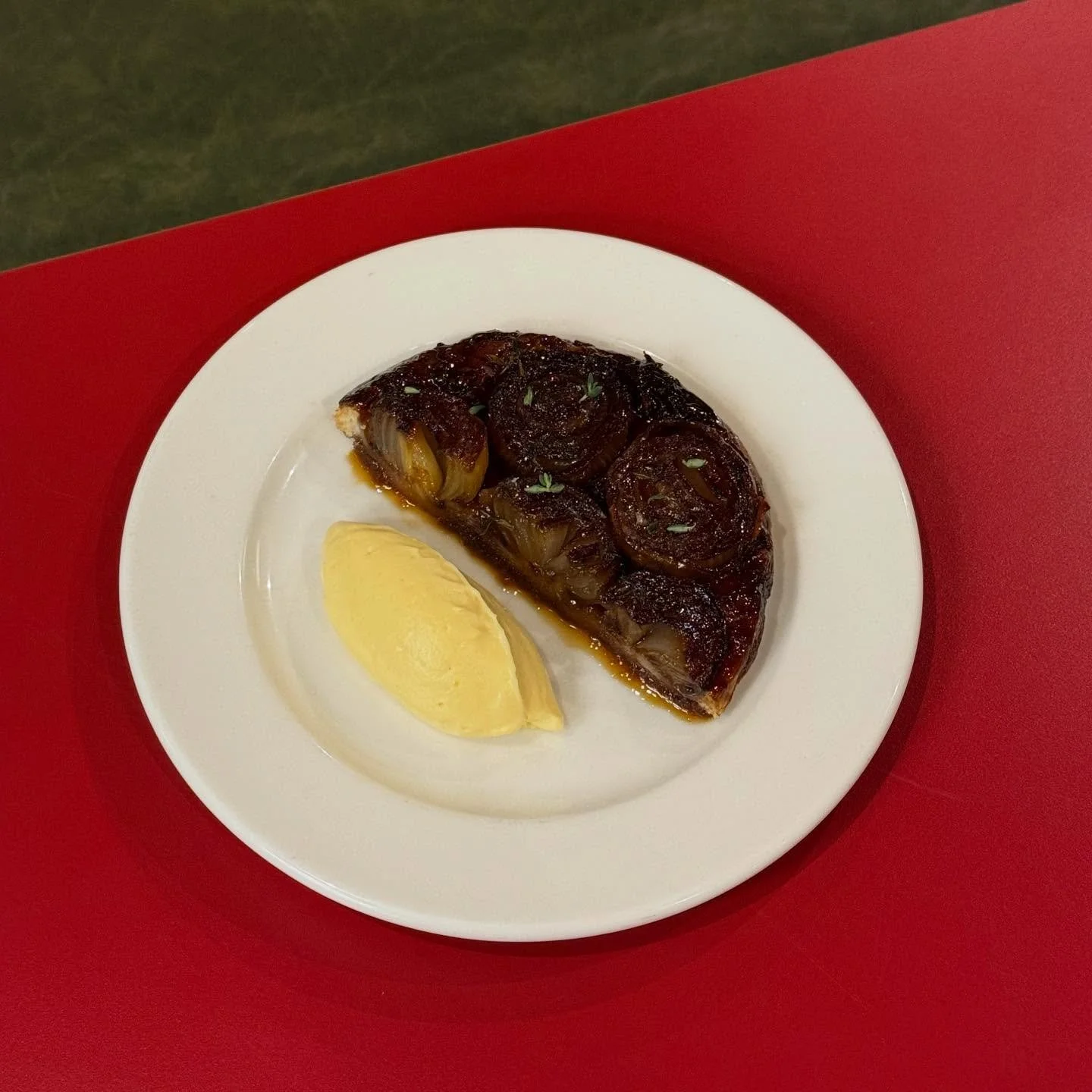 Meet our newest dish - Roscoff Onion Tarte Tatin with Idiazabal Royale 🧅

These sweet and sticky caramelised Roscoffs sit on top of crispy pastry covered in the charred glossy sauce. Served with a good dollop of smooth, creamy Idialazbal Royale that