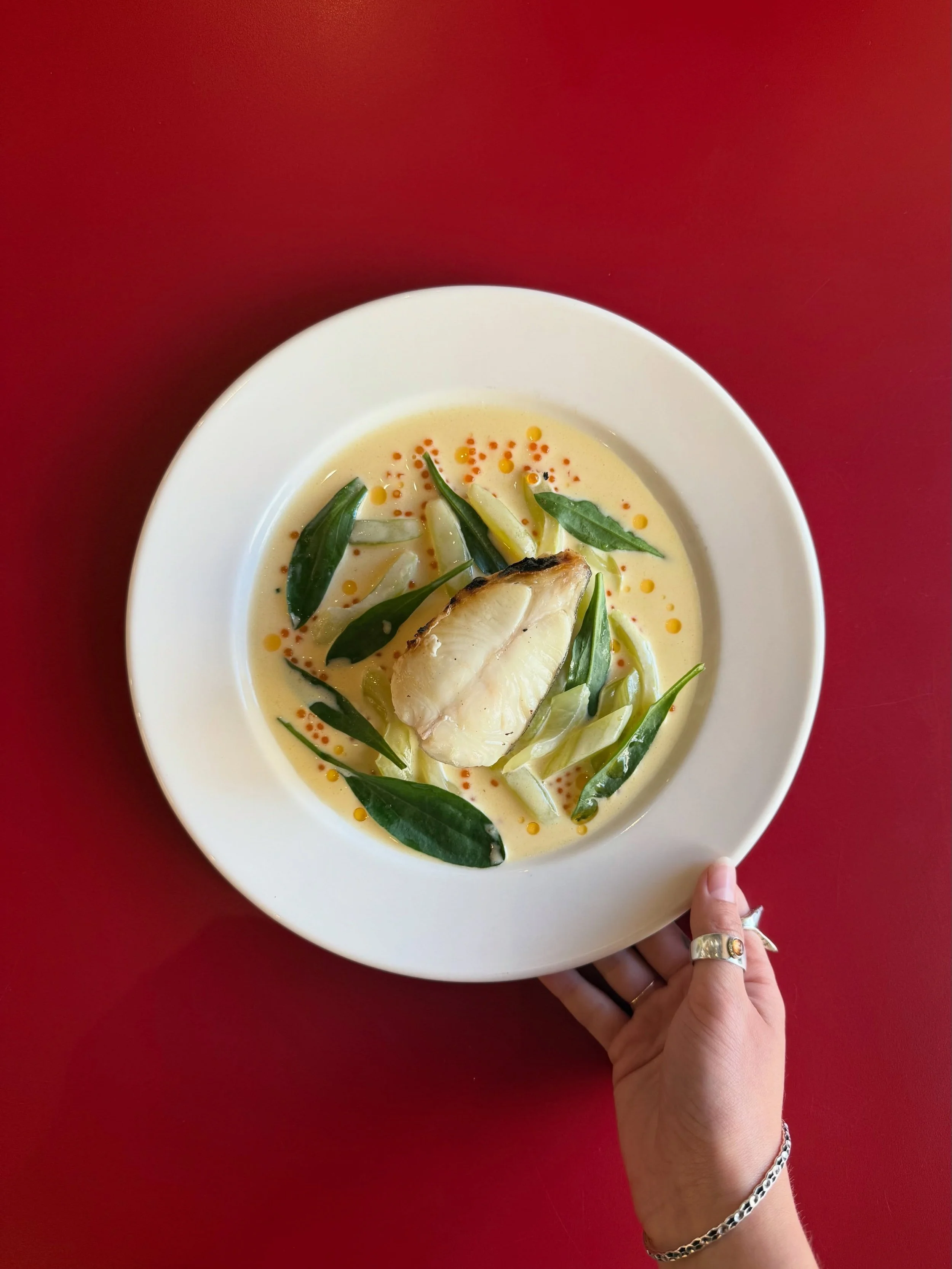 Meet our new BBQ Halibut with celery and pickled cucumber, on top of Halibut Veloute with trout roe, finished off with Sea Aster 🐟

Delicate fish paired with a light, moreish sauce with pops of salinity and crunch YUM