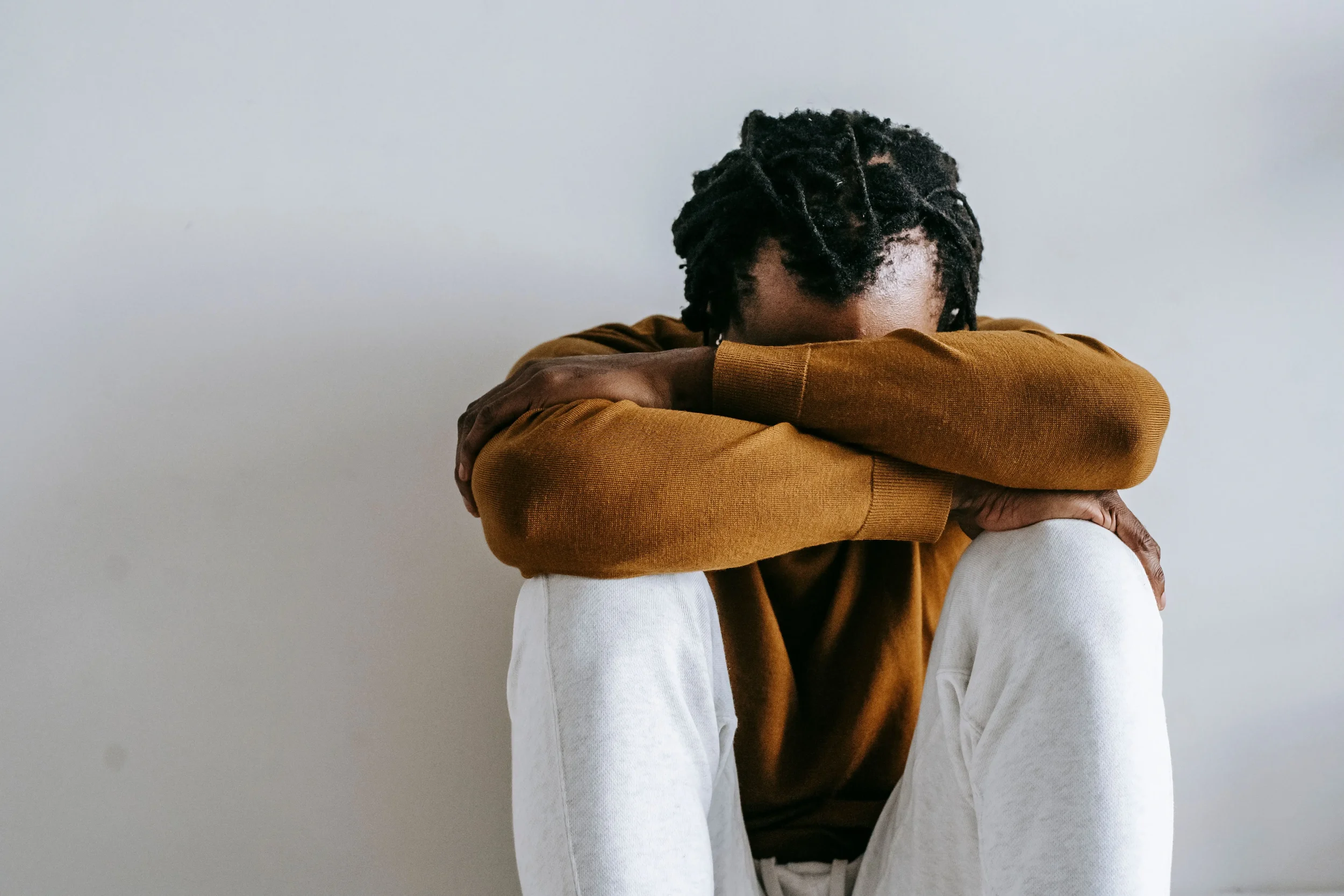 A man feeling sad after his breakup, head buried in his arms