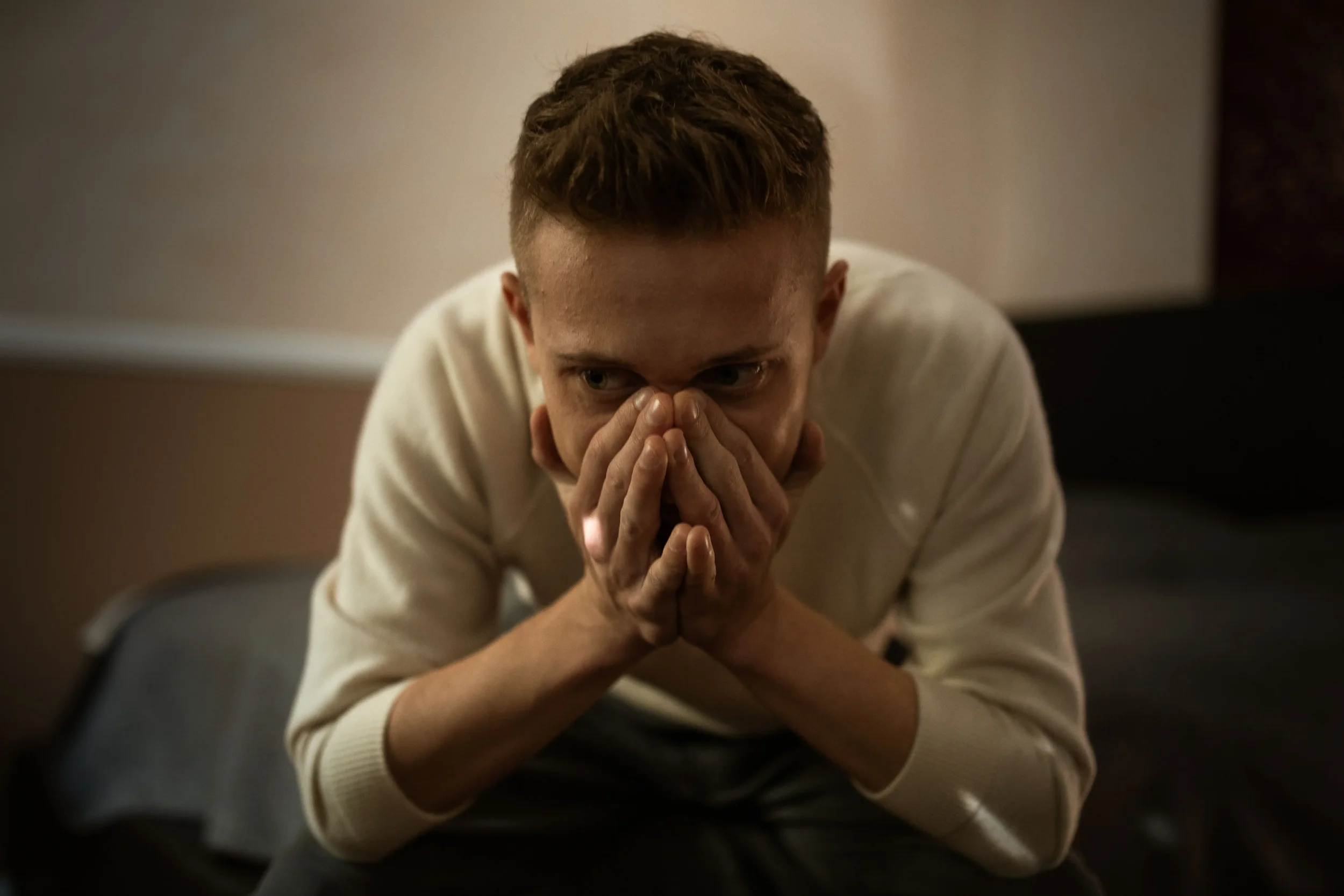 A man holding his head in his hands