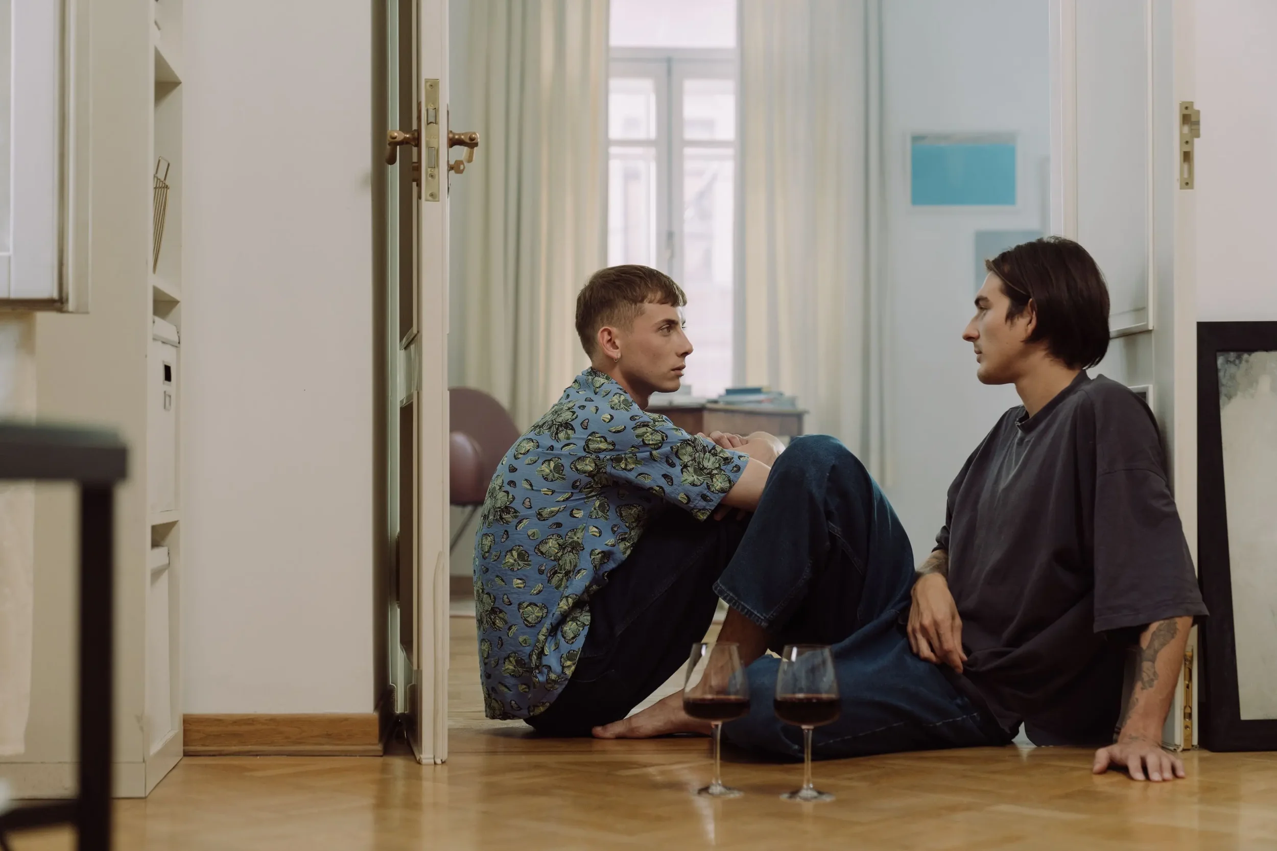 A couple sitting on the floor in conversation